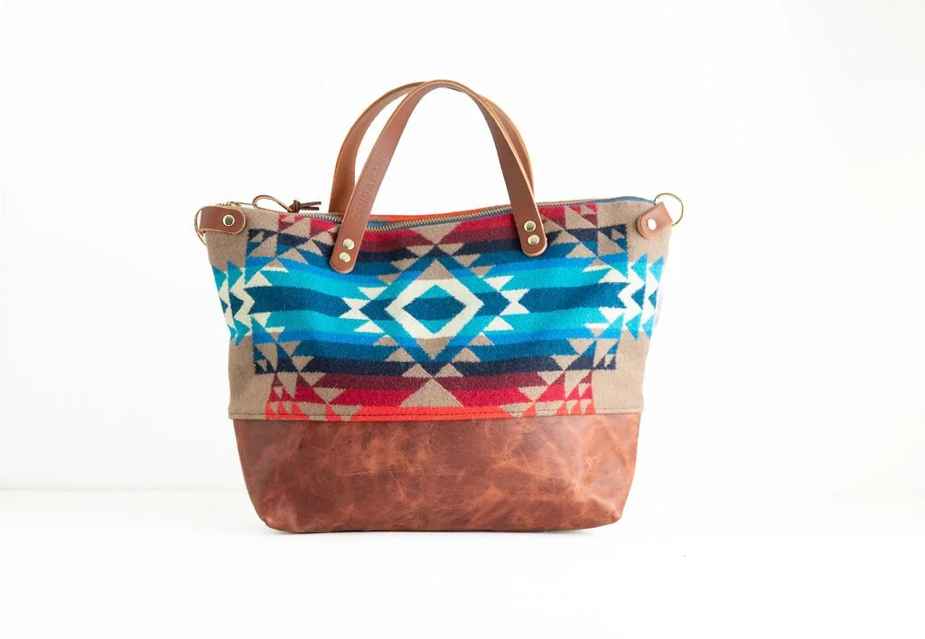 Handmade Pilot Rock wool crossbody purse with brown leather bottom and handles, crafted in Portland