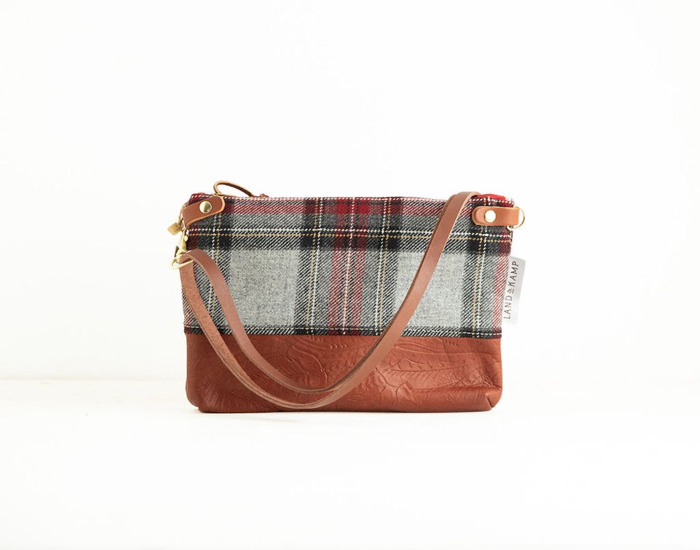 Detail view of the Grey Stewart Tartan wool 3-in-1 wristlet bag featuring YKK zipper and leather trim by Land & Kamp with stamped leather