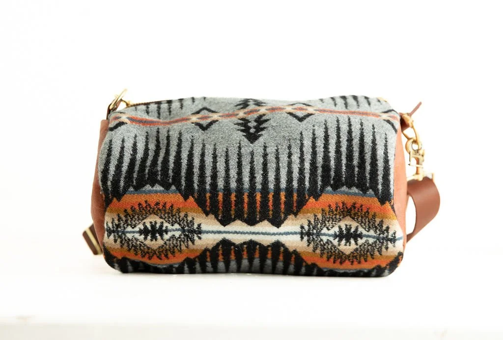 Handmade wool barrel crossbody bag in Shale Mountain pattern with leather strap and trim, crafted in Portland