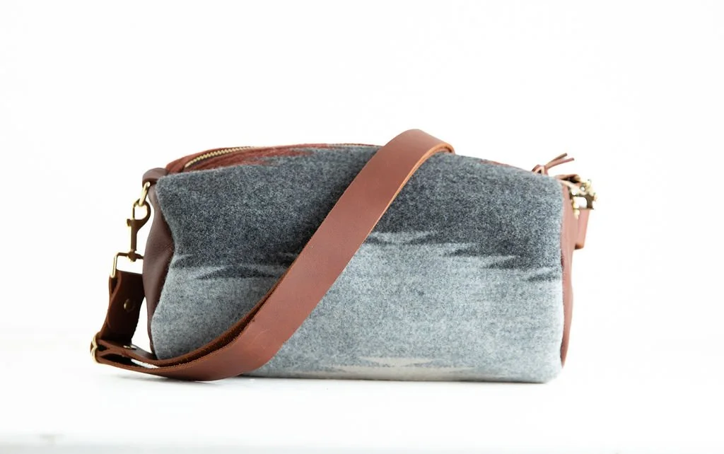 Detail view of the Wool Barrel Crossbody Bag in Anvil Cream featuring YKK zipper, leather pull, and premium hardware by Land & Kamp