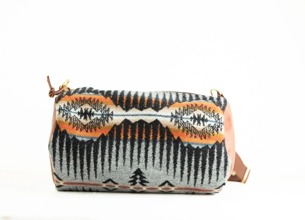 Handmade wool barrel crossbody bag in Shale Mountain pattern with leather strap and trim, crafted in Portland