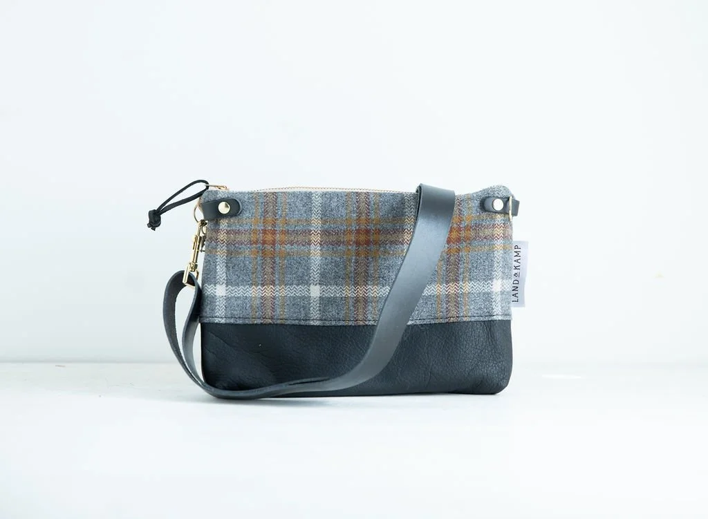 Detail view of the Grey and Gold Plaid wool 3-in-1 wristlet bag featuring YKK zipper and leather trim by Land & Kamp