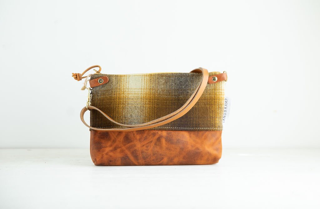 Detail view of the Brown and Gold Ombre wool 3-in-1 wristlet bag featuring YKK zipper and leather trim by Land & Kamp