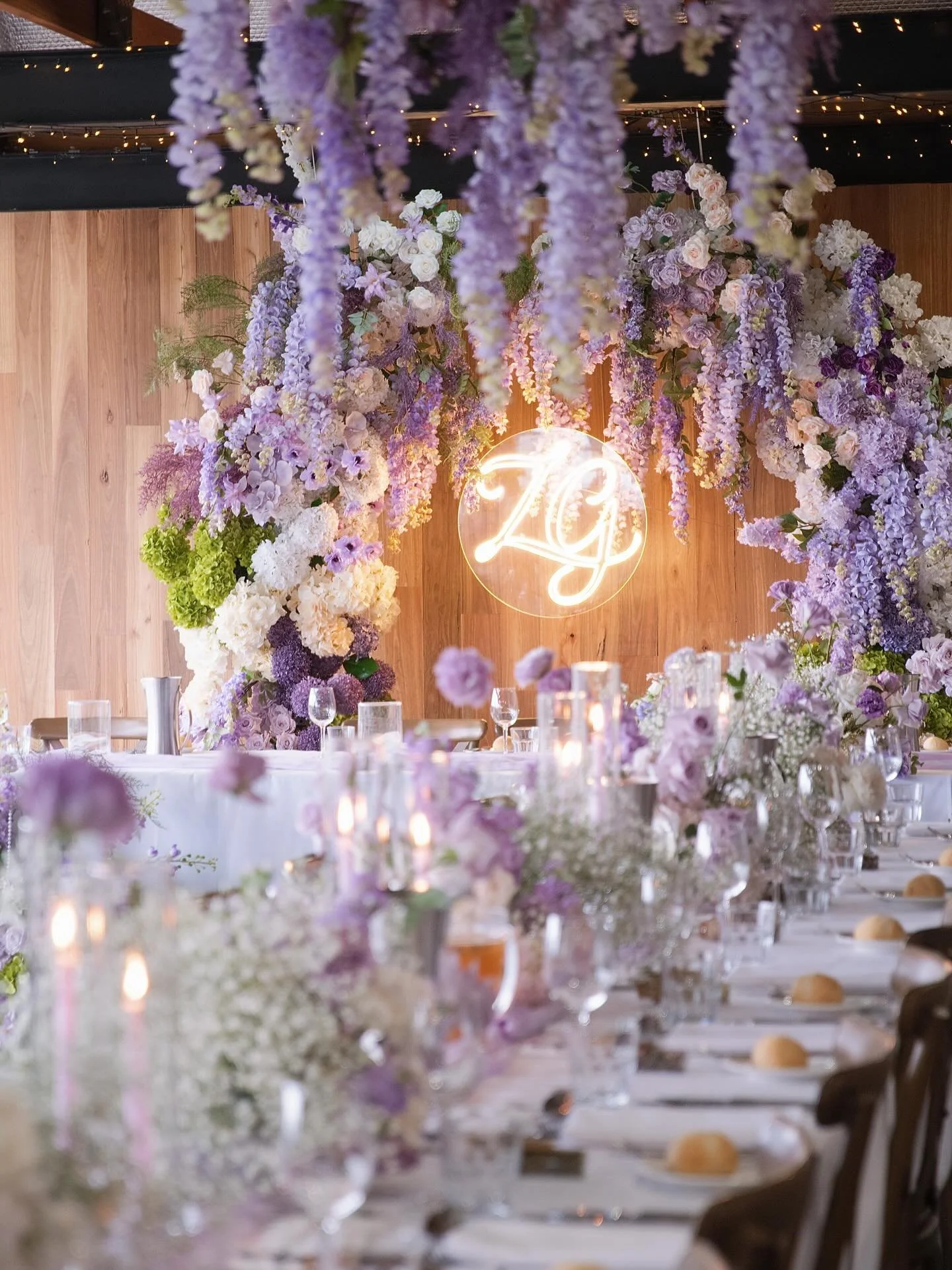 Cascading wisteria flowed softly from above,
draping the space in gentle lavender tones.

The florals moved naturally, creating an atmosphere that felt calm, romantic,
and effortlessly elegant.
Nothing was forced &mdash; every detail was designed to 