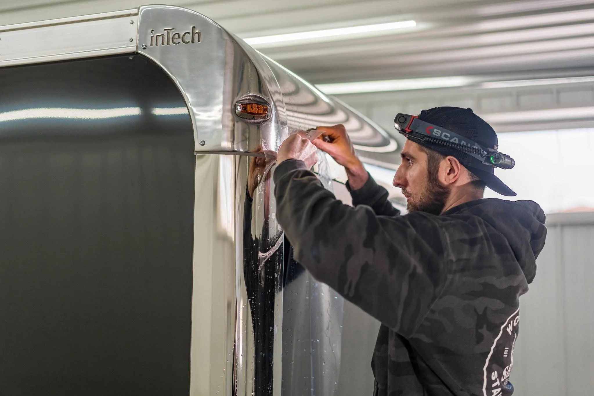 Professional Detailer applying PPF to Trailer 