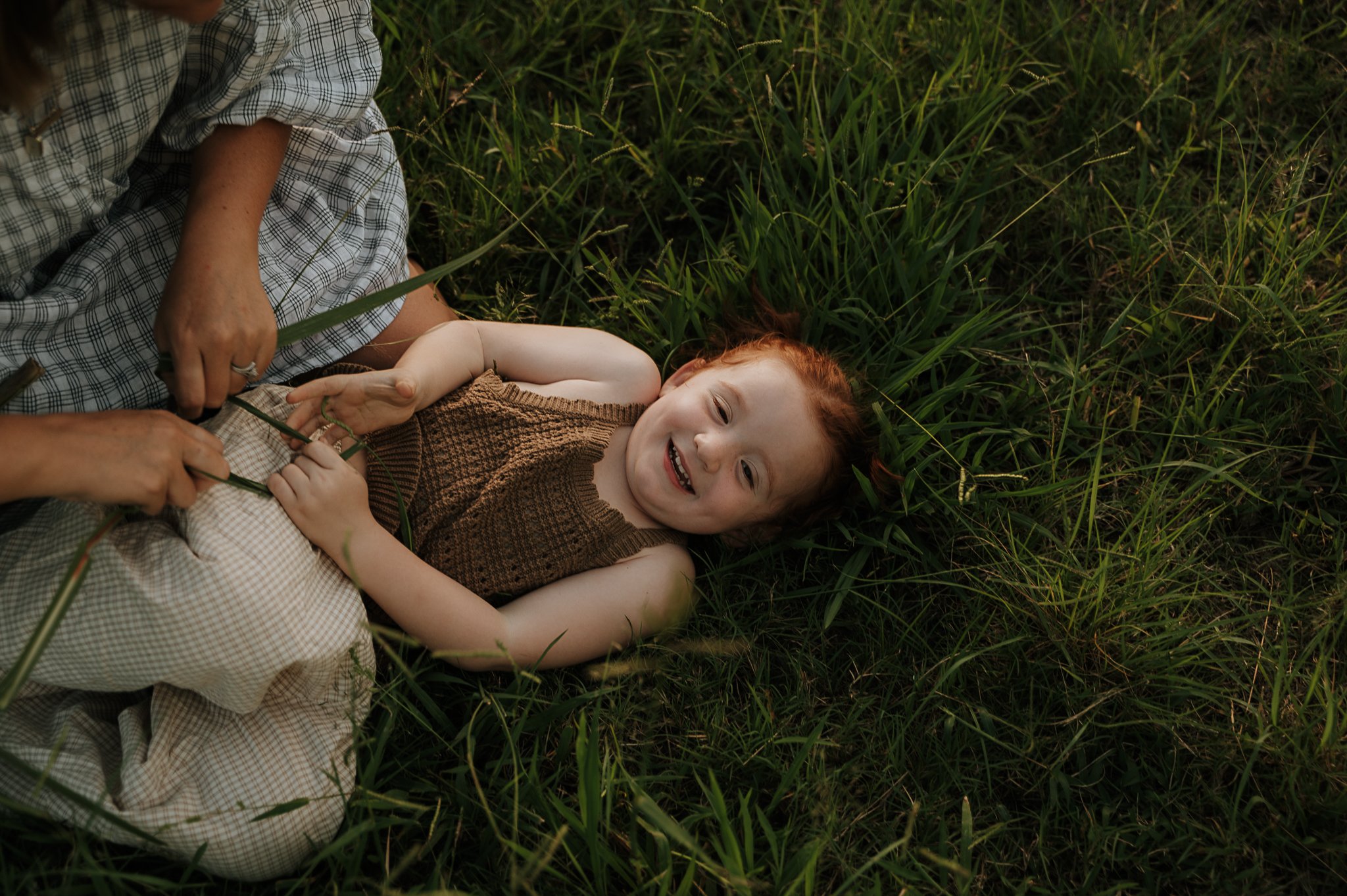 girl-laughing-in-the-grass-tweed-valley.jpg
