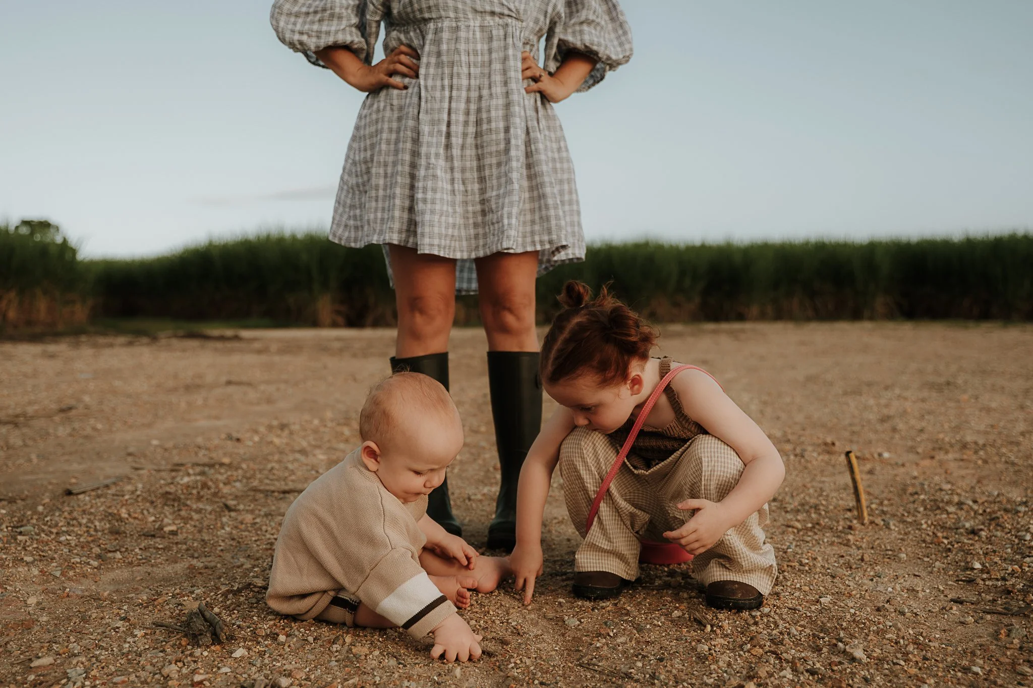 kids-crouched-on-the-ground-mum-watching.jpg