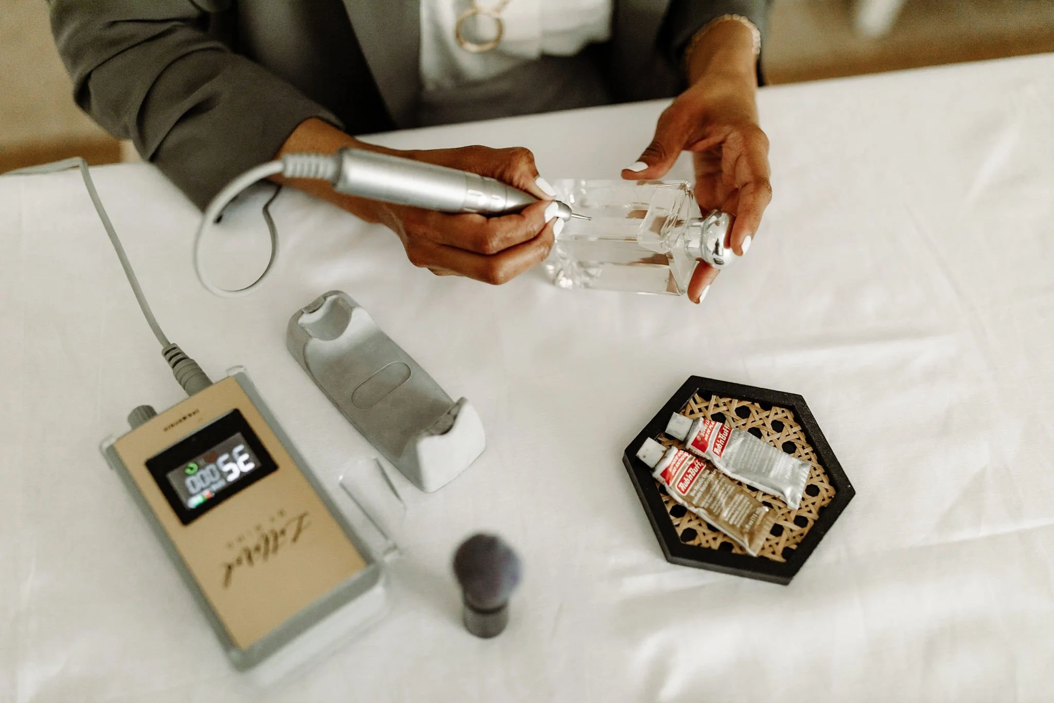 Hand-engraved calligraphy on a glass fragrance bottle for a luxury brand event in NYC.