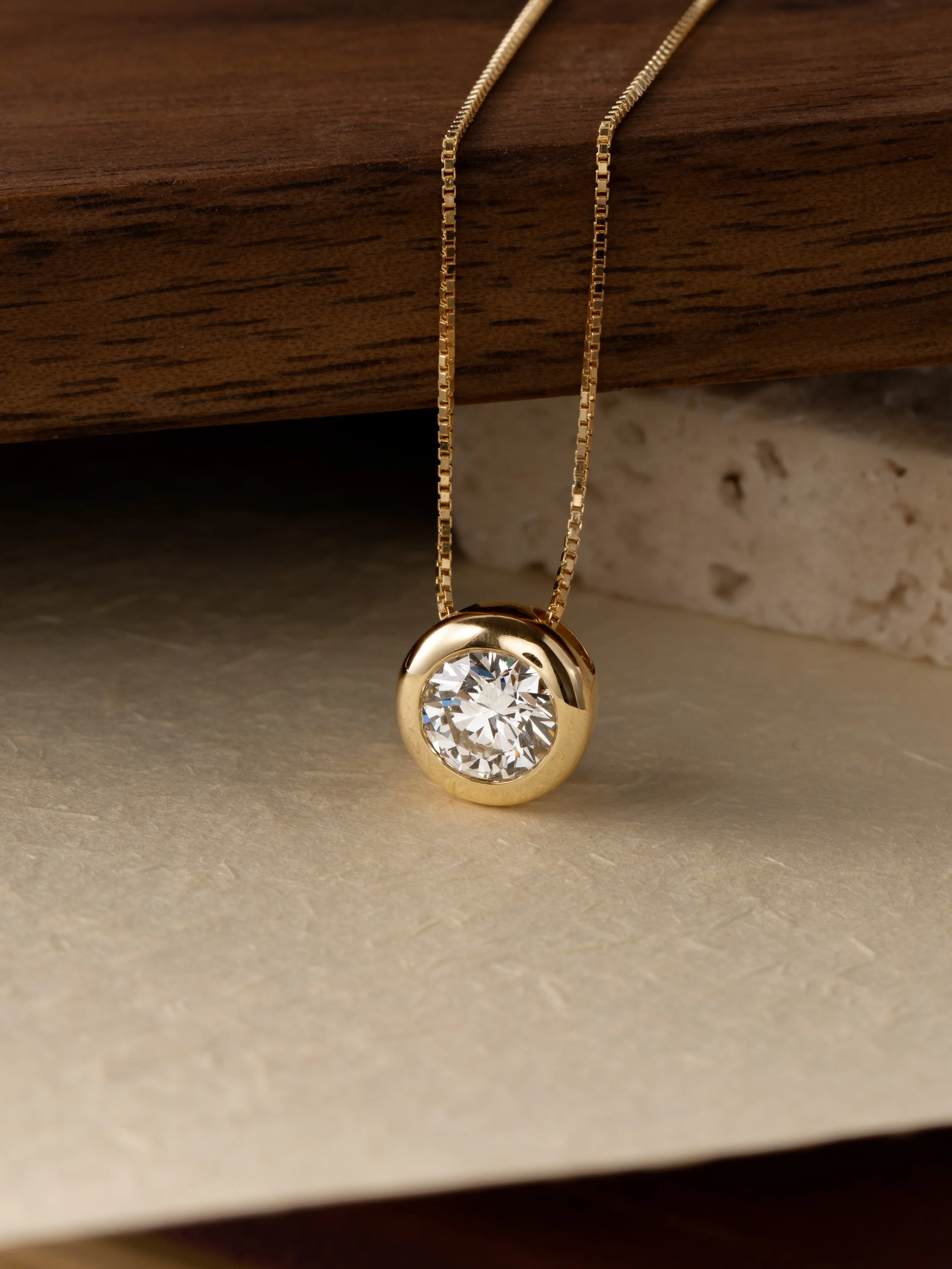 Everdear memorial diamond necklace featuring a round brilliant cut cremation diamond in a carat gold bezel setting on a delicate box chain