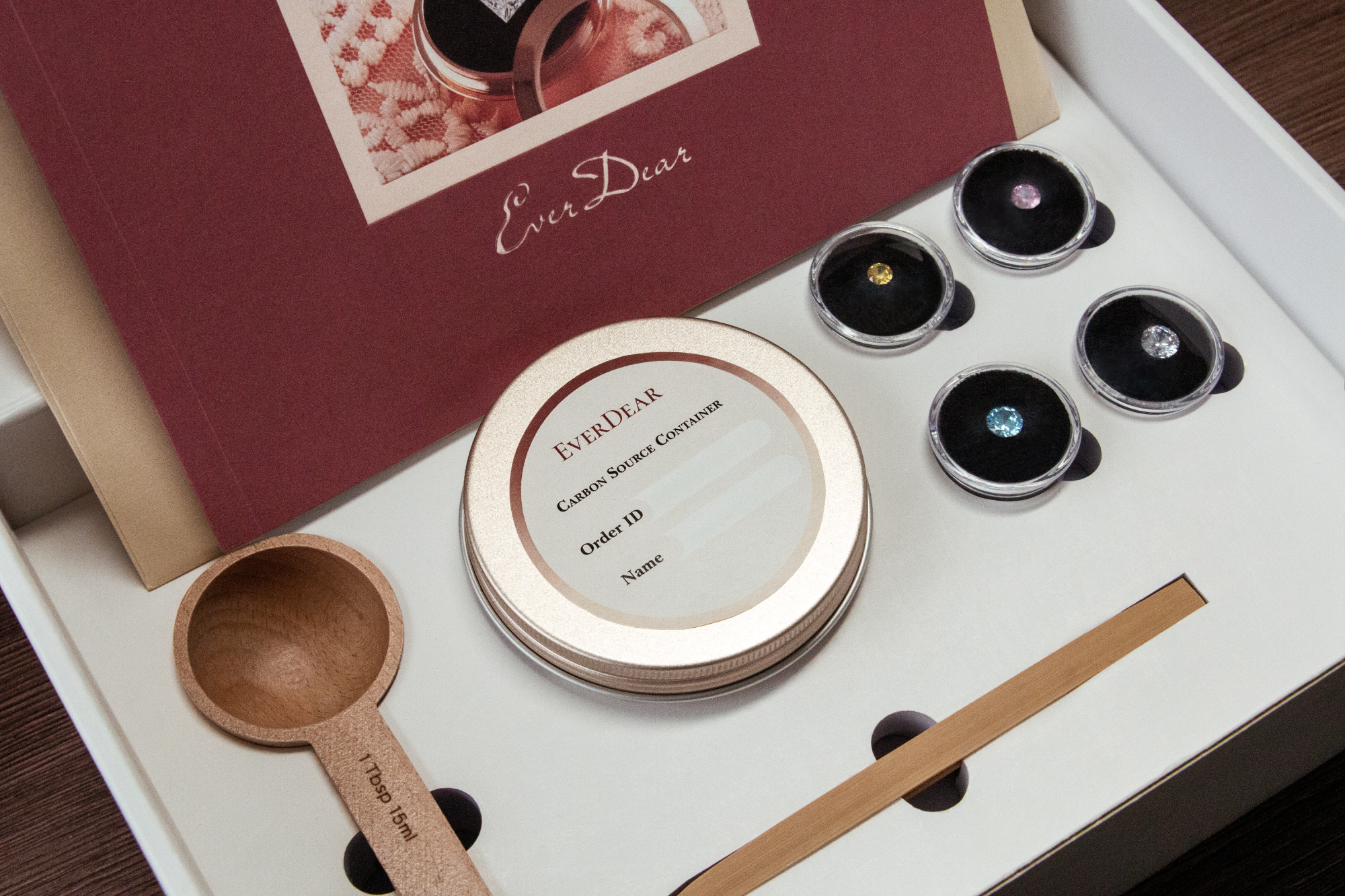 EverDear welcome kit with a wooden 1 tablespoon measuring scoop, a carbon source container, and four sample diamonds