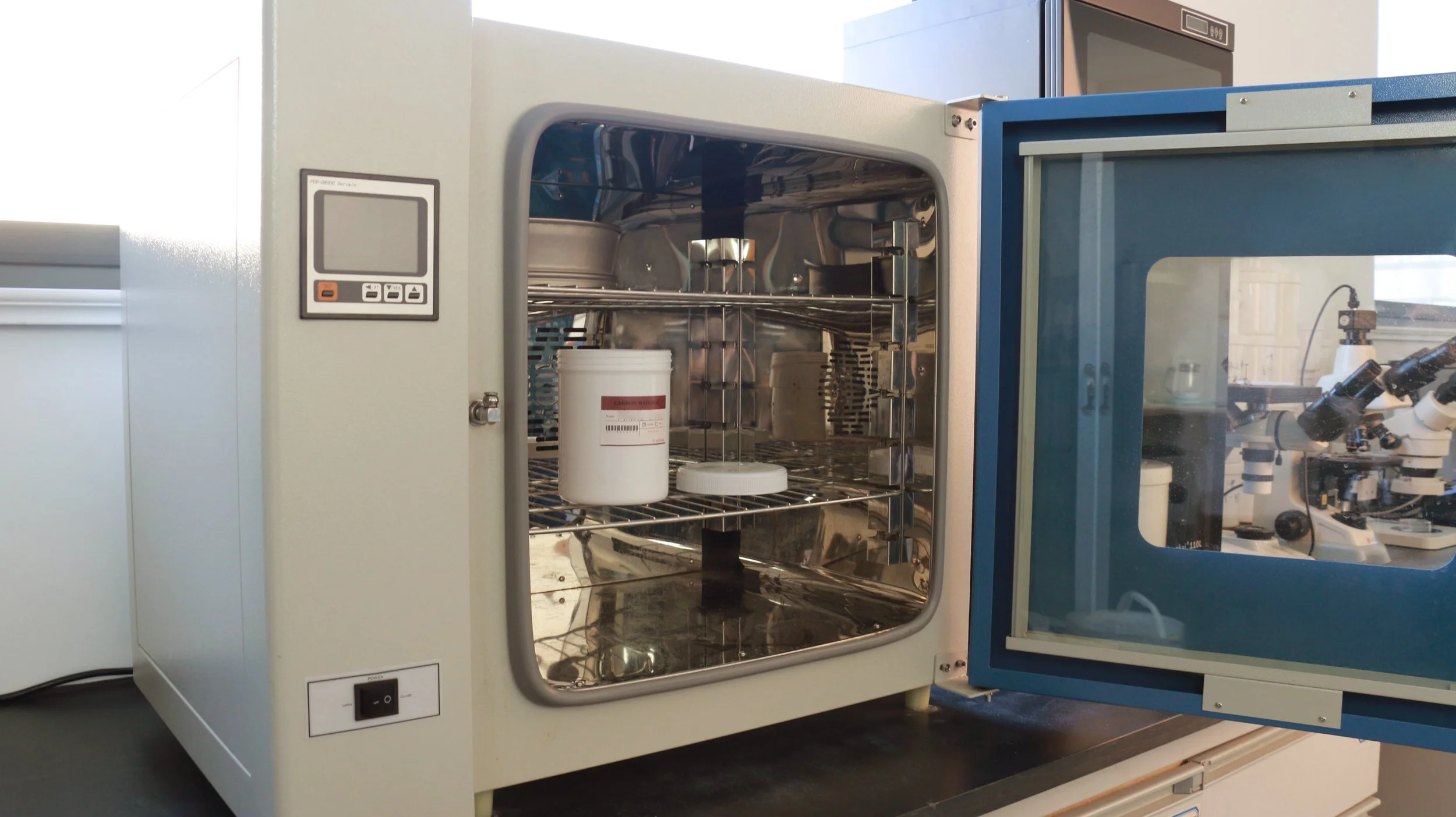 A labeled sample container inside an EverDear lab oven, showing how each order is processed individually and tracked throughout the memorial diamond process.