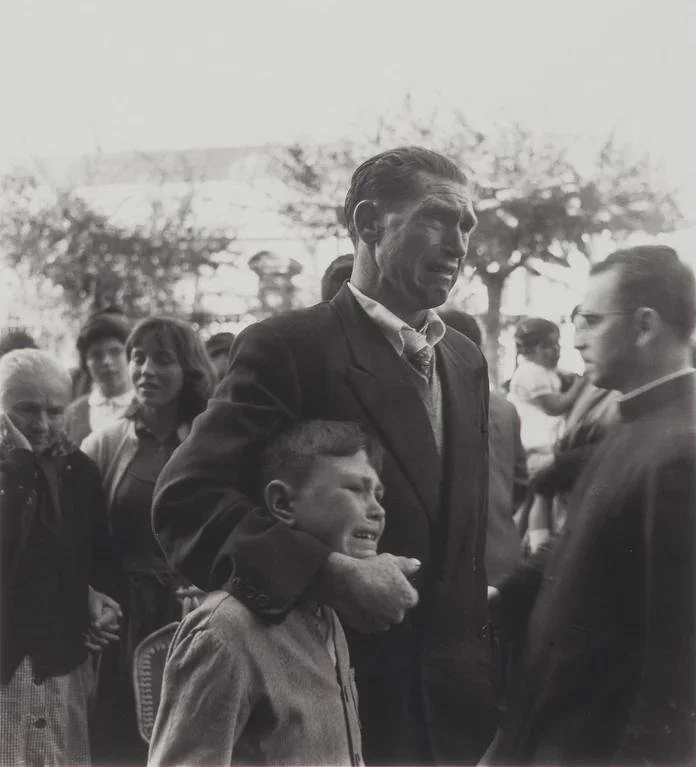 Father and son crying as they say goodbye to their relatives who are boarding a boat to Buenos Aires in search of a better life during the economic hardship in Spain. (1957)