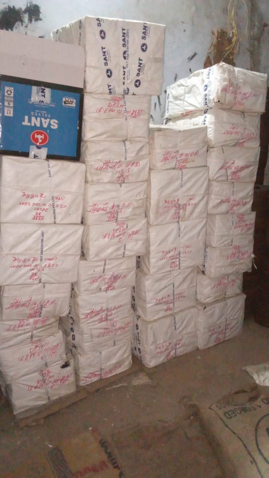 Sant Valves factory-sealed cartons stacked at Vijay Sales Corporation Delhi warehouse — original Sant Valves Pvt. Ltd. consignment with Delhi dispatch markings