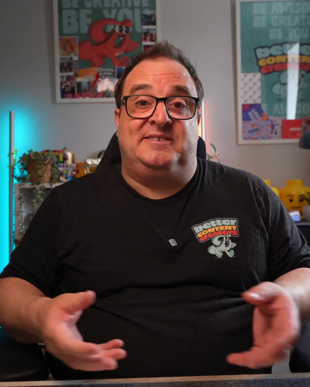 Darren in office with black t-shirt on and office background smiling