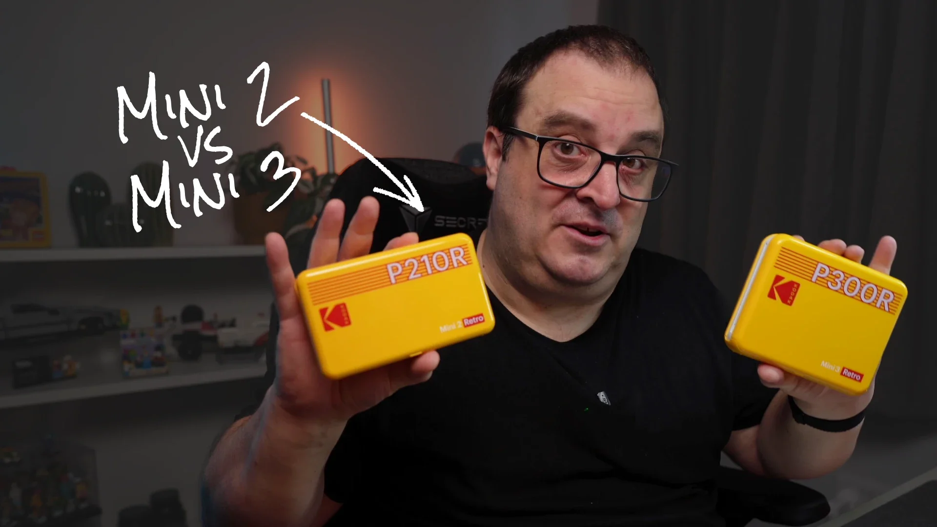 Darren holding the Kodak Mini 2 and 3 printers linking to a video comparing them on YouTube