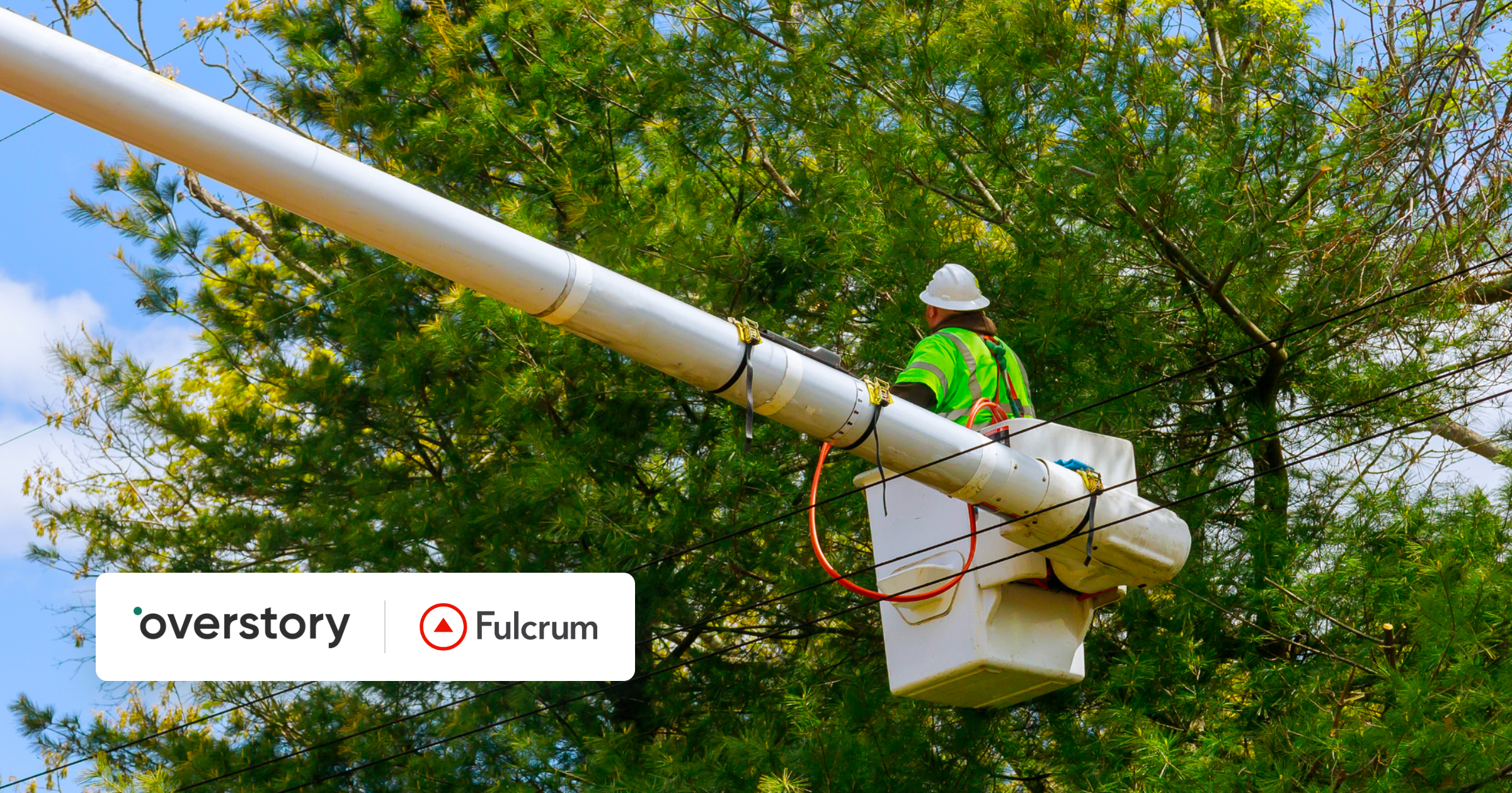 Line worker in a bucket truck trimming trees near power lines.