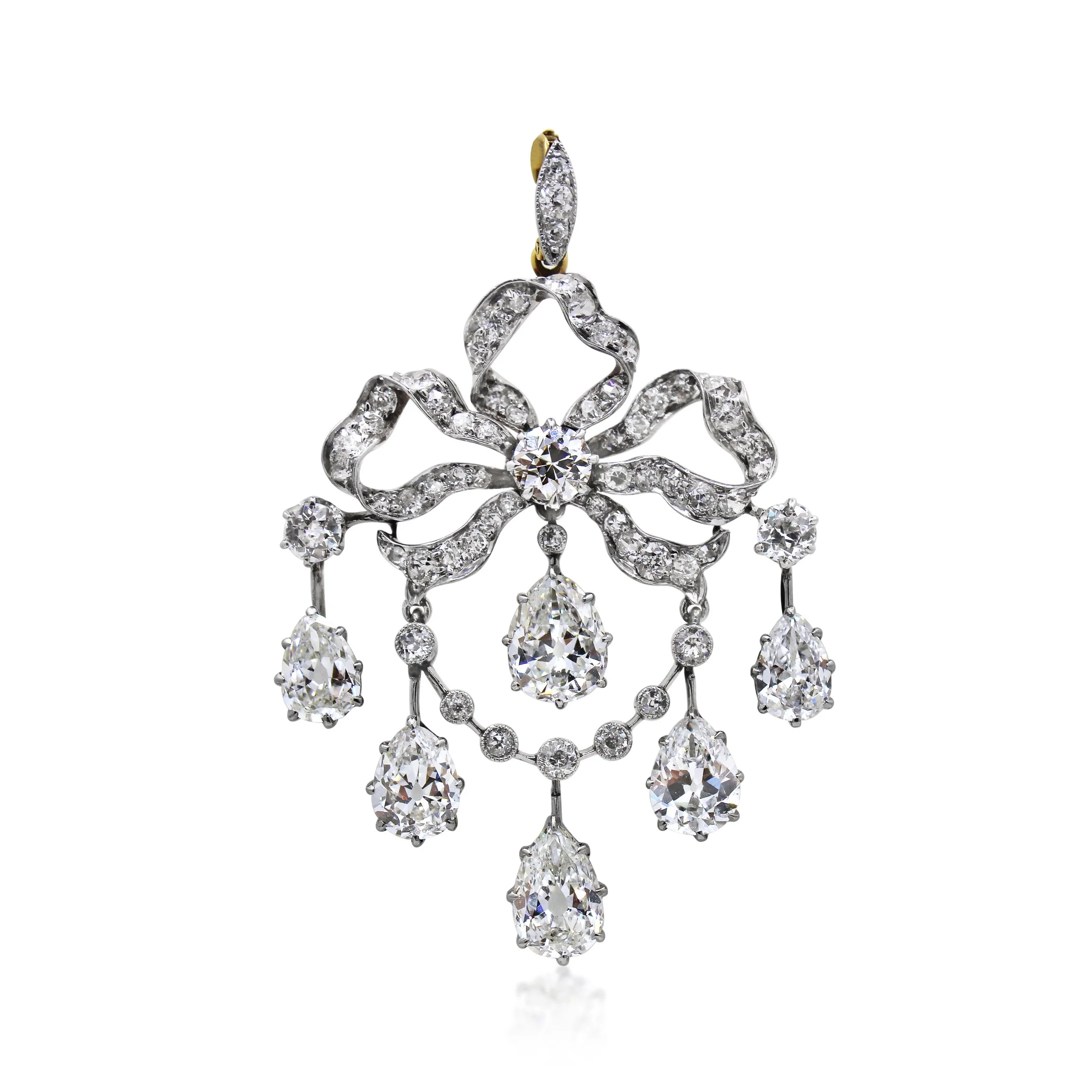 SN5999 - Edwardian Diamond Garland Pendant of Ribbon Bow Design. Set throughout with old-cut diamonds and suspending an articulated diamond swag enhanced by six old-cut pear-shaped diamonds