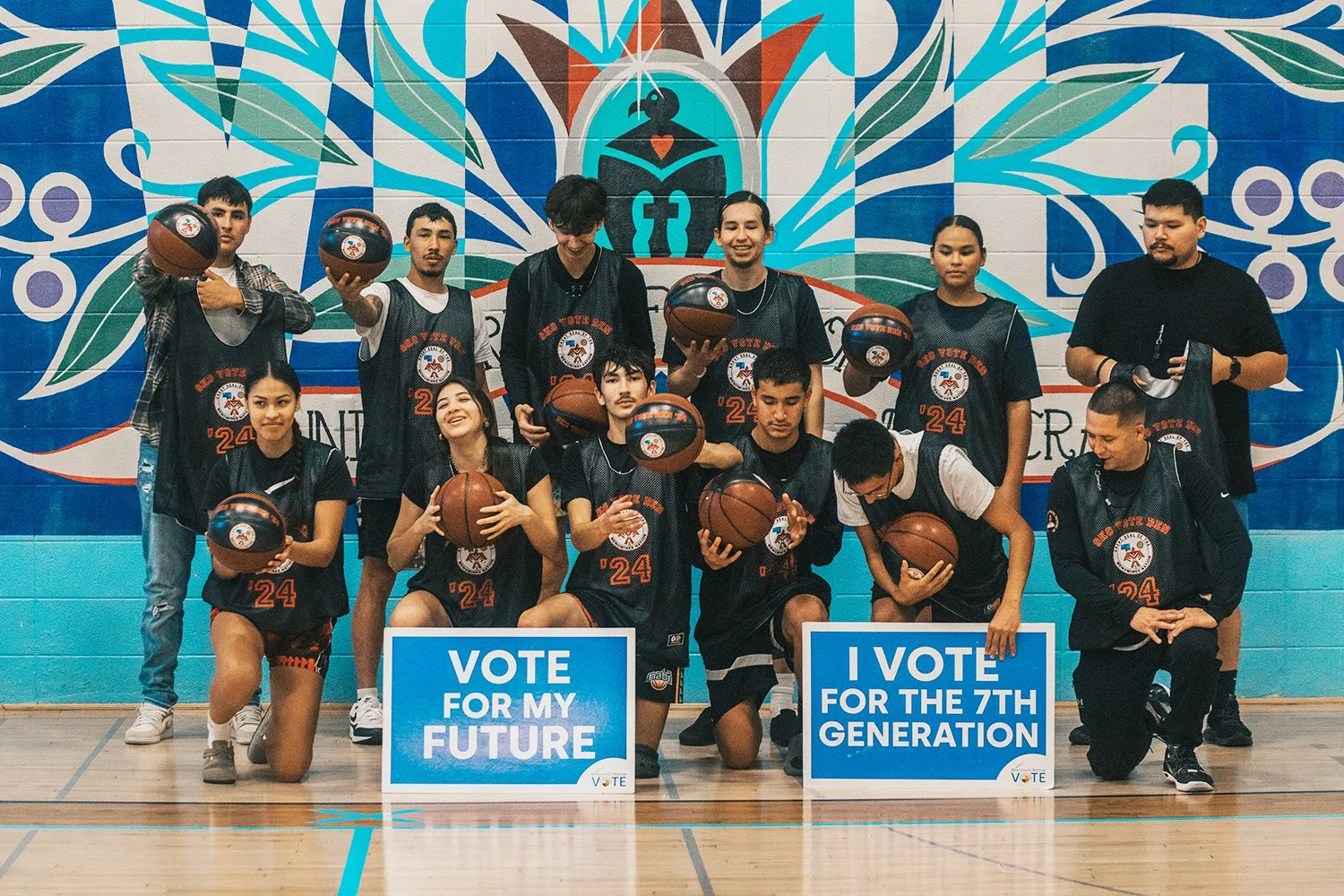 Young Native basketball players smiling and posing for photo on court