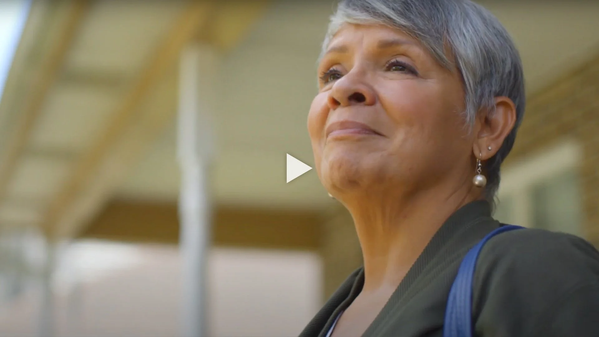 Closeup of woman standing under an overhang.