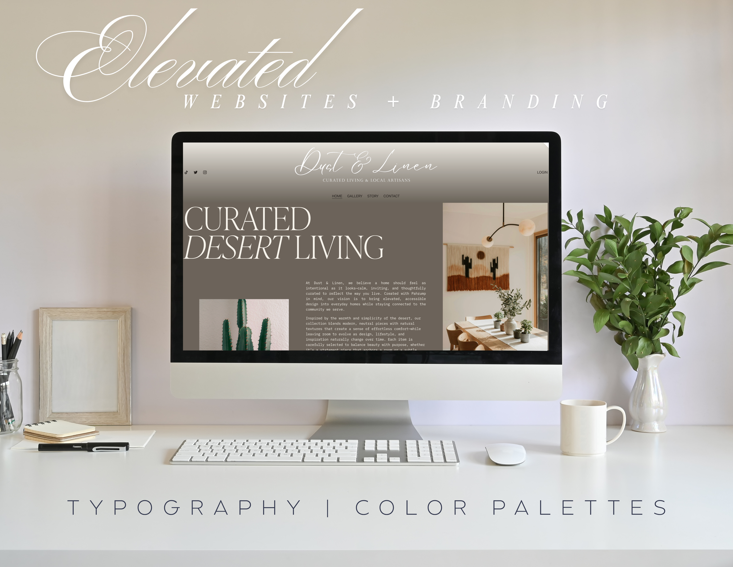 A computer on a white desk displays a website for Dust & Linen with the headline 'Curated Desert Living.' The desk also has a notebook, pen, keyboard, mouse, a small picture frame, a cup, and a vase with green leaves. To the right is a larger vase with green foliage.