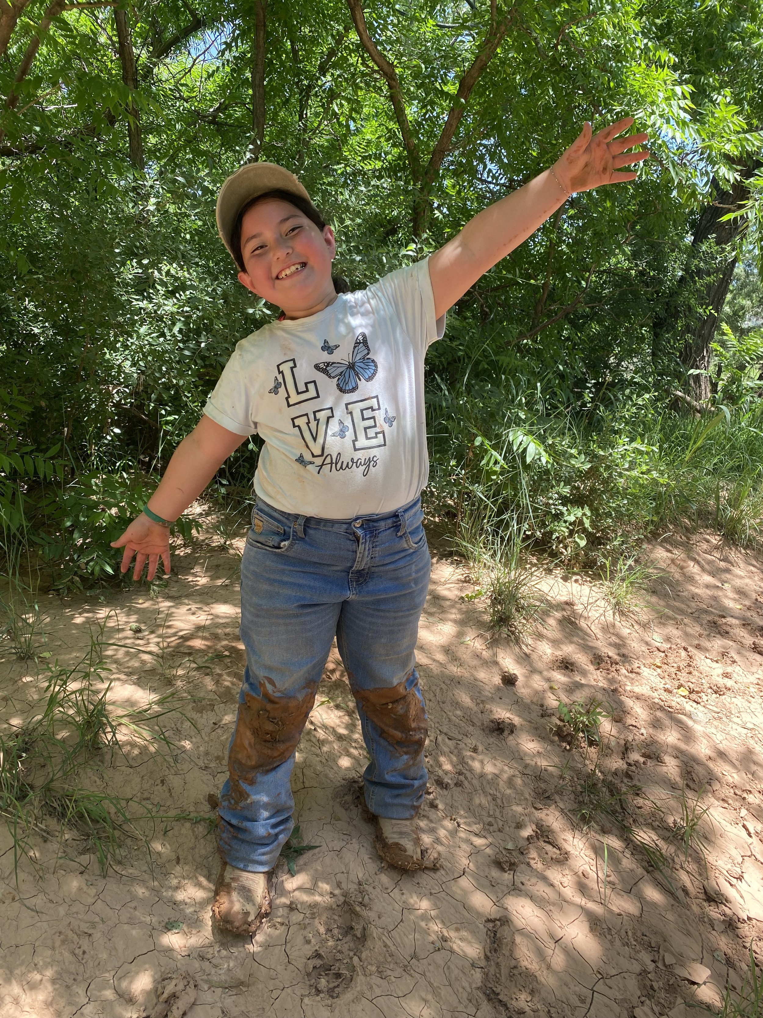 Girl slipped in mud documentinng having a good time enjoying nature.