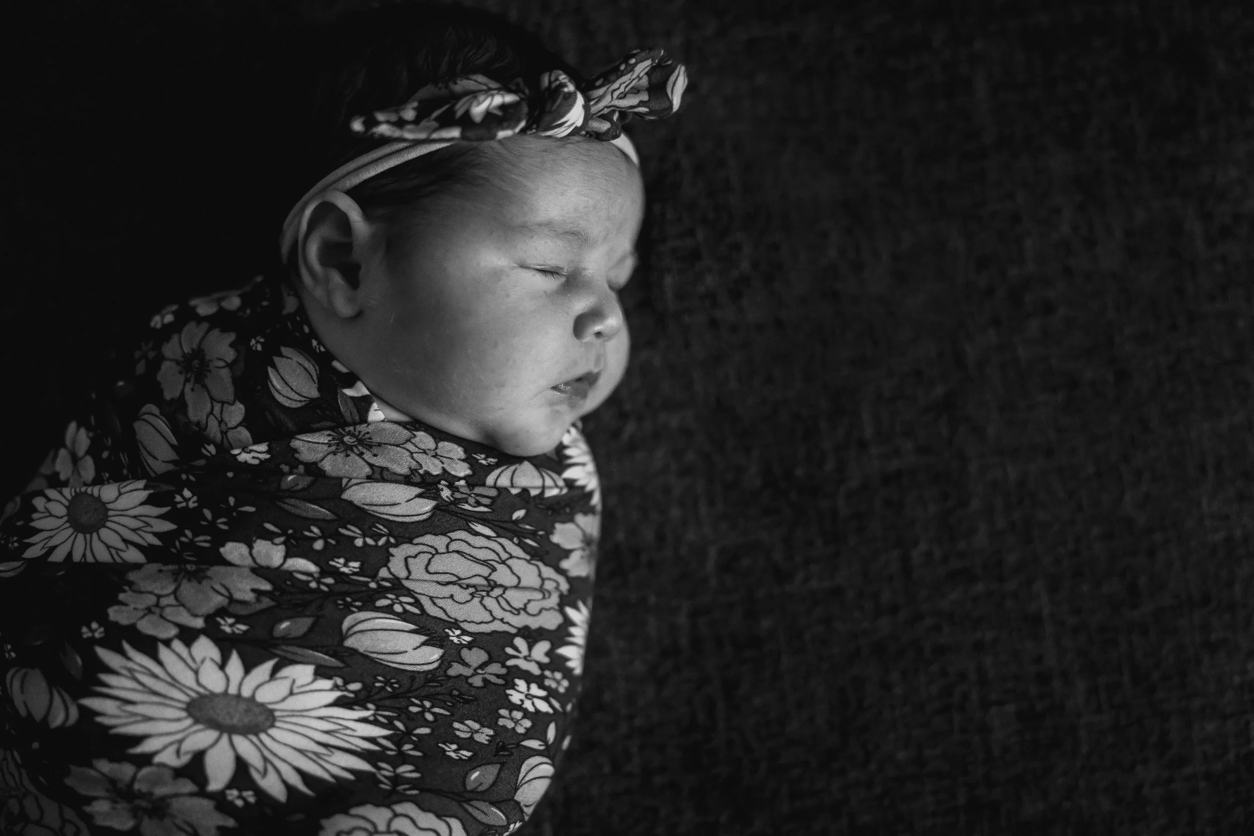 Lifestyle newborn photography Amarillo Texas featuring a sleeping baby photo in black and white.