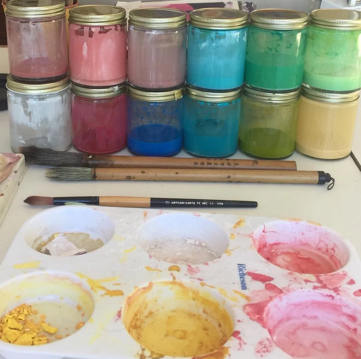 mixed gouache paint jars, brushes, palette