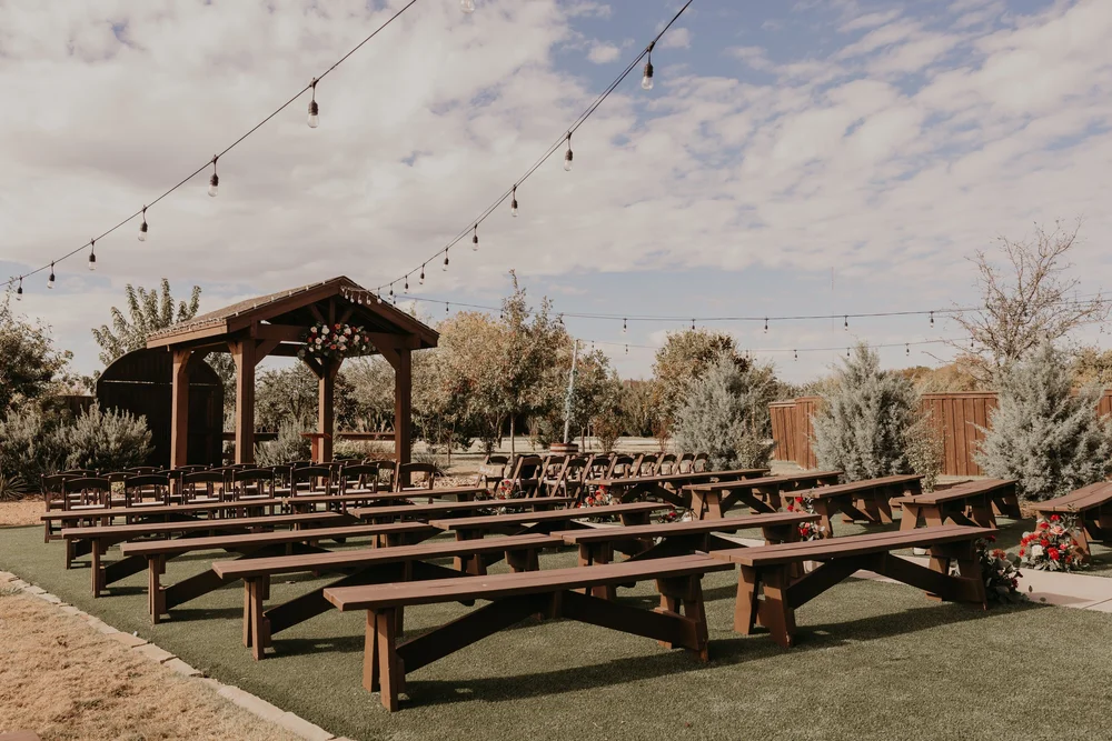 Outdoor ceremony arbor and seating at The Melissa Barn