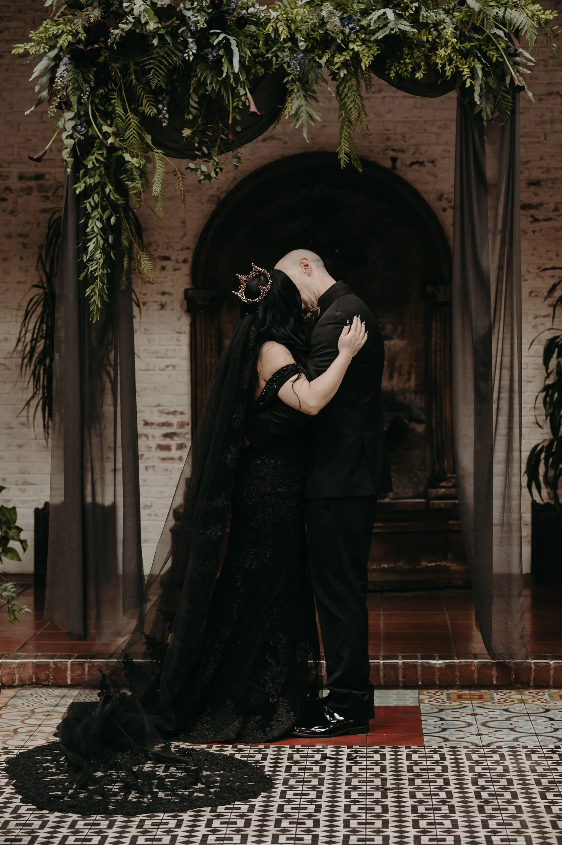 Gothic Ceremony Kiss under Greenery Arch