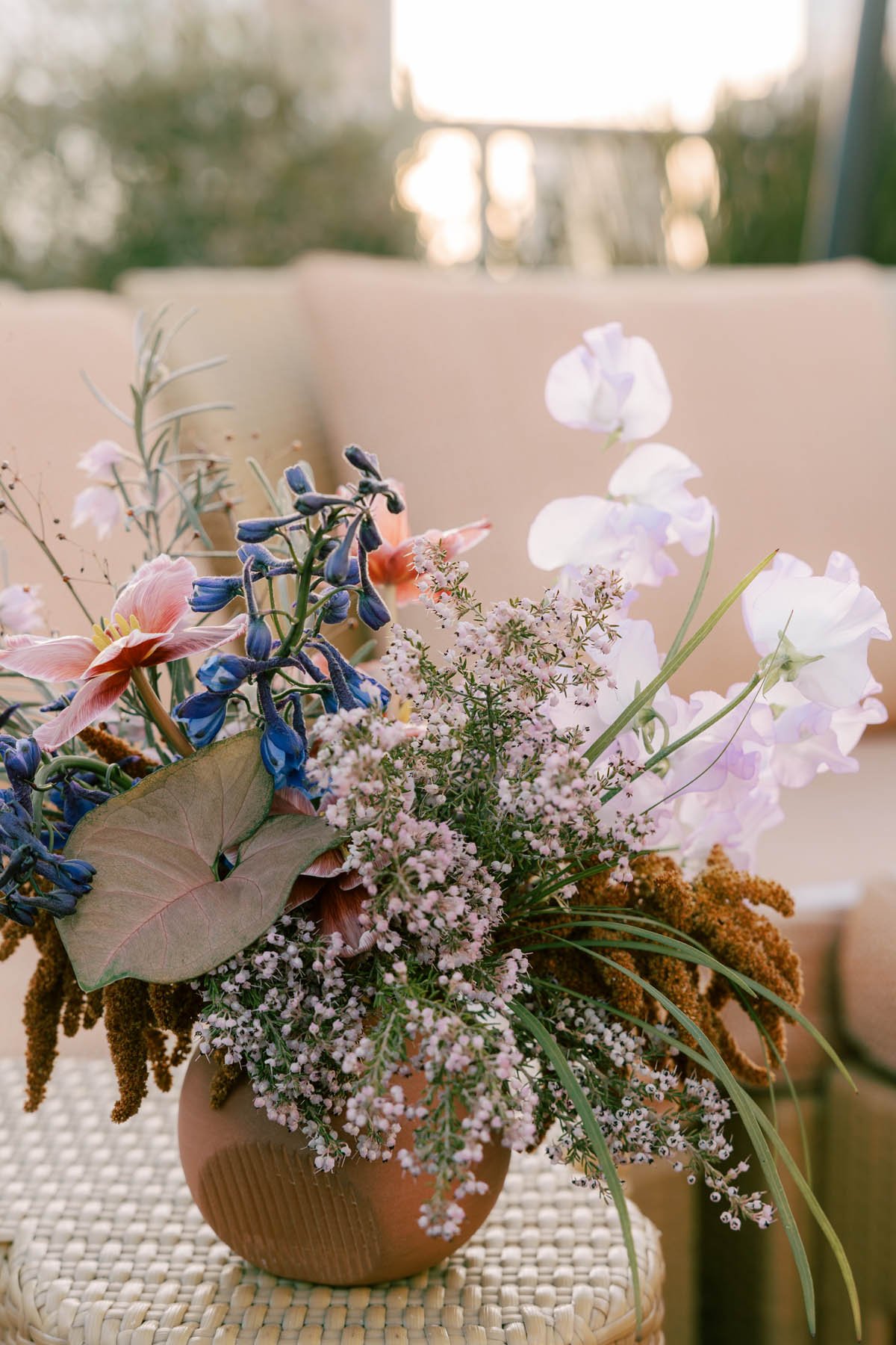 Terracotta Vase with Spring Wildflowers in Blush and Indigo at Hotel Per La