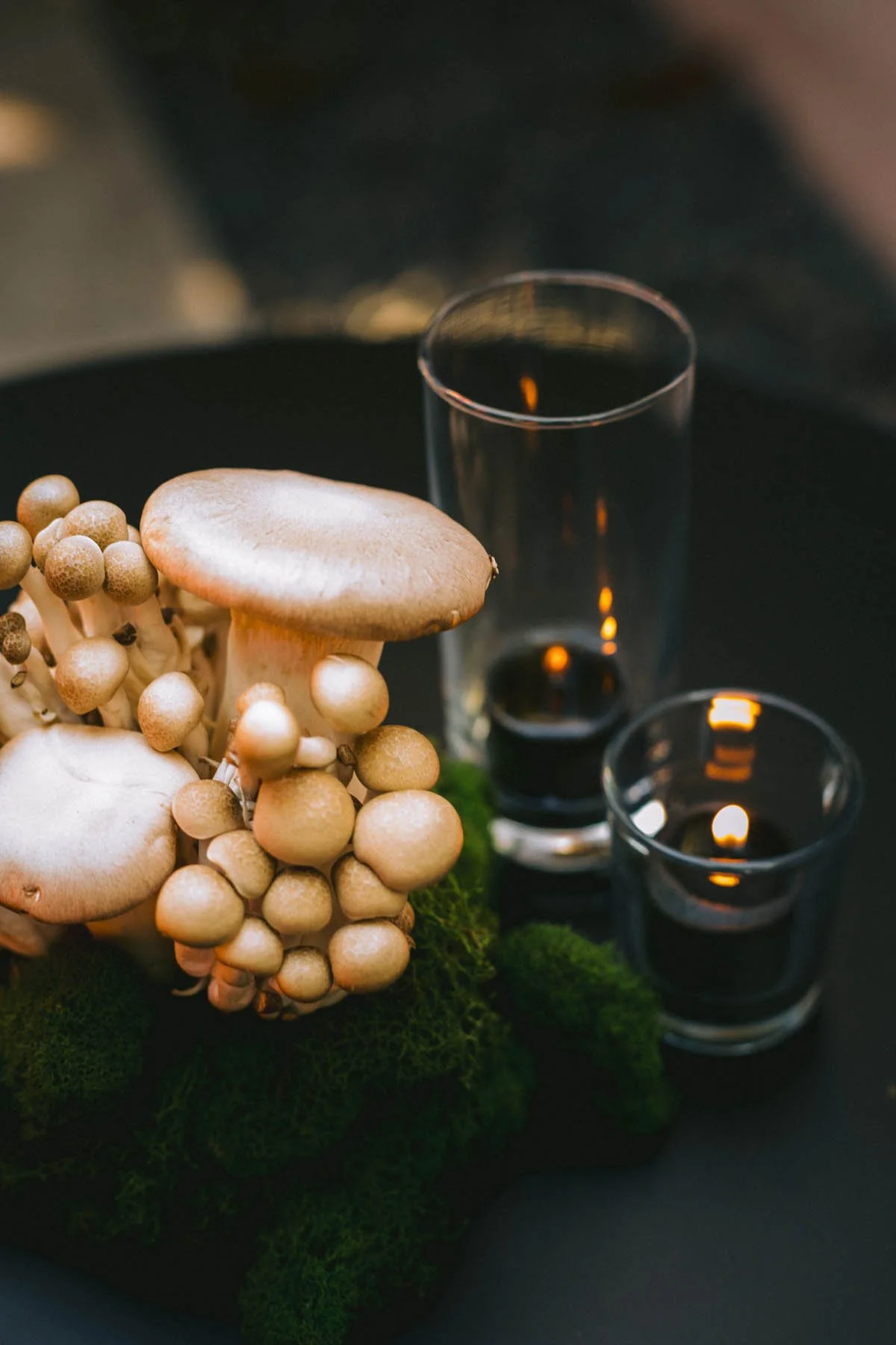 Modern Mushroom Centerpiece with Black Candles and Moss