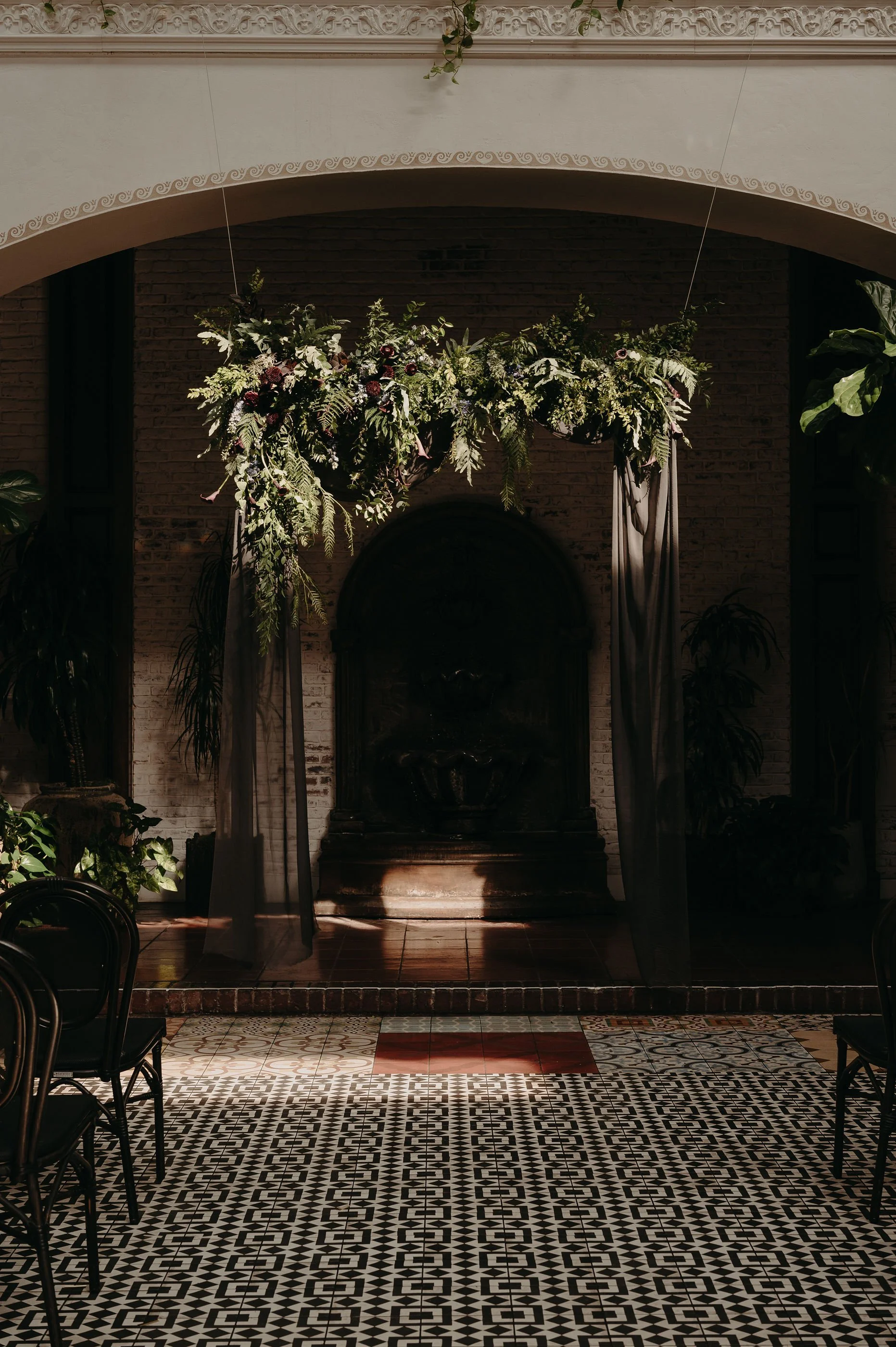 Moody Greenery Ceremony Arch with Draped Fabric