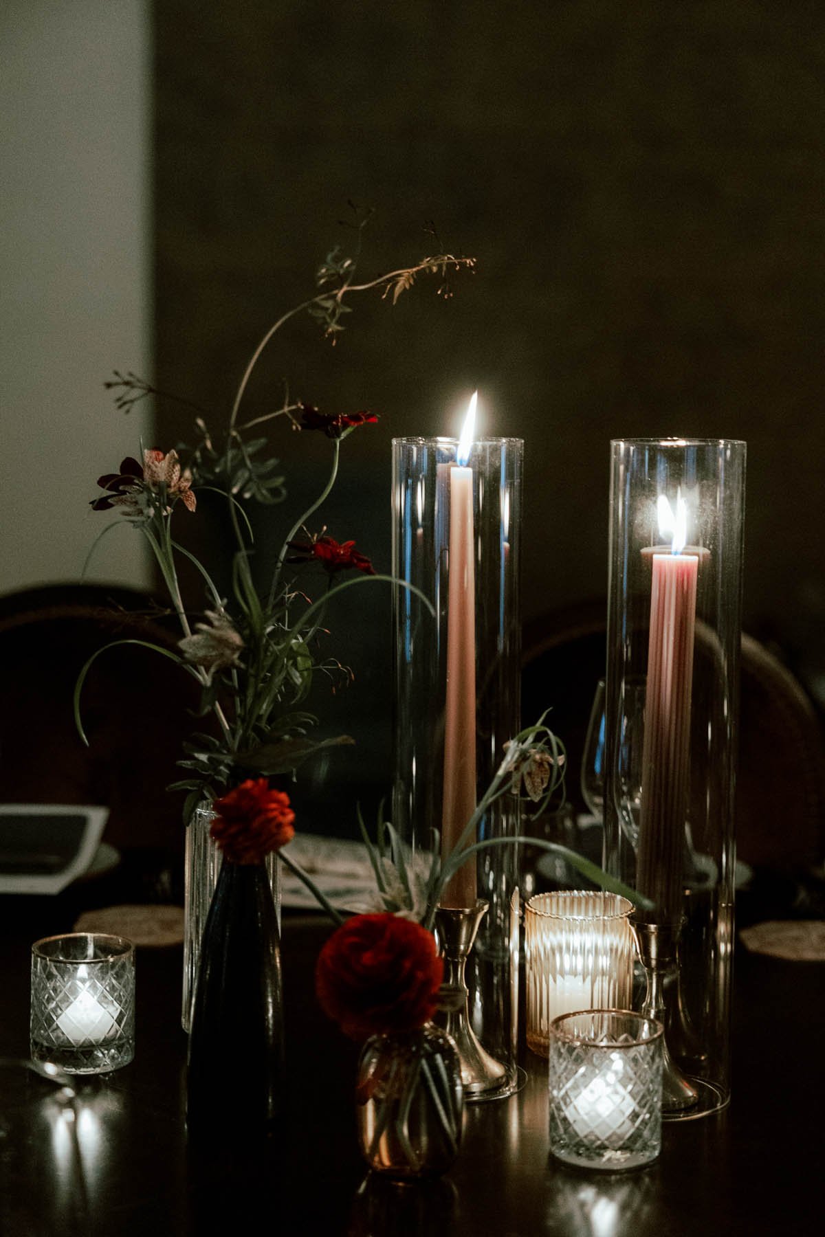Candlelit Floral Still Life with Crimson Ranunculus and Amber Glow