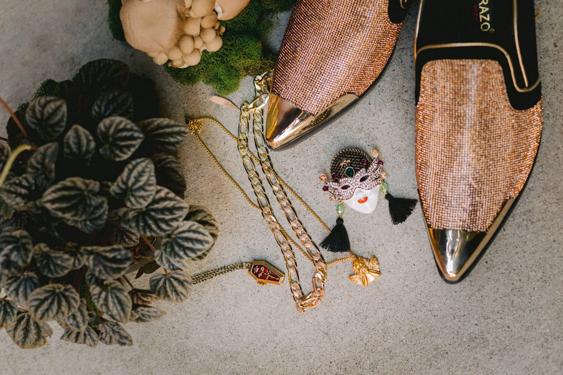 Eclectic Wedding Flat Lay with Gold Shoes, Jewelry, and Velvet Foliage