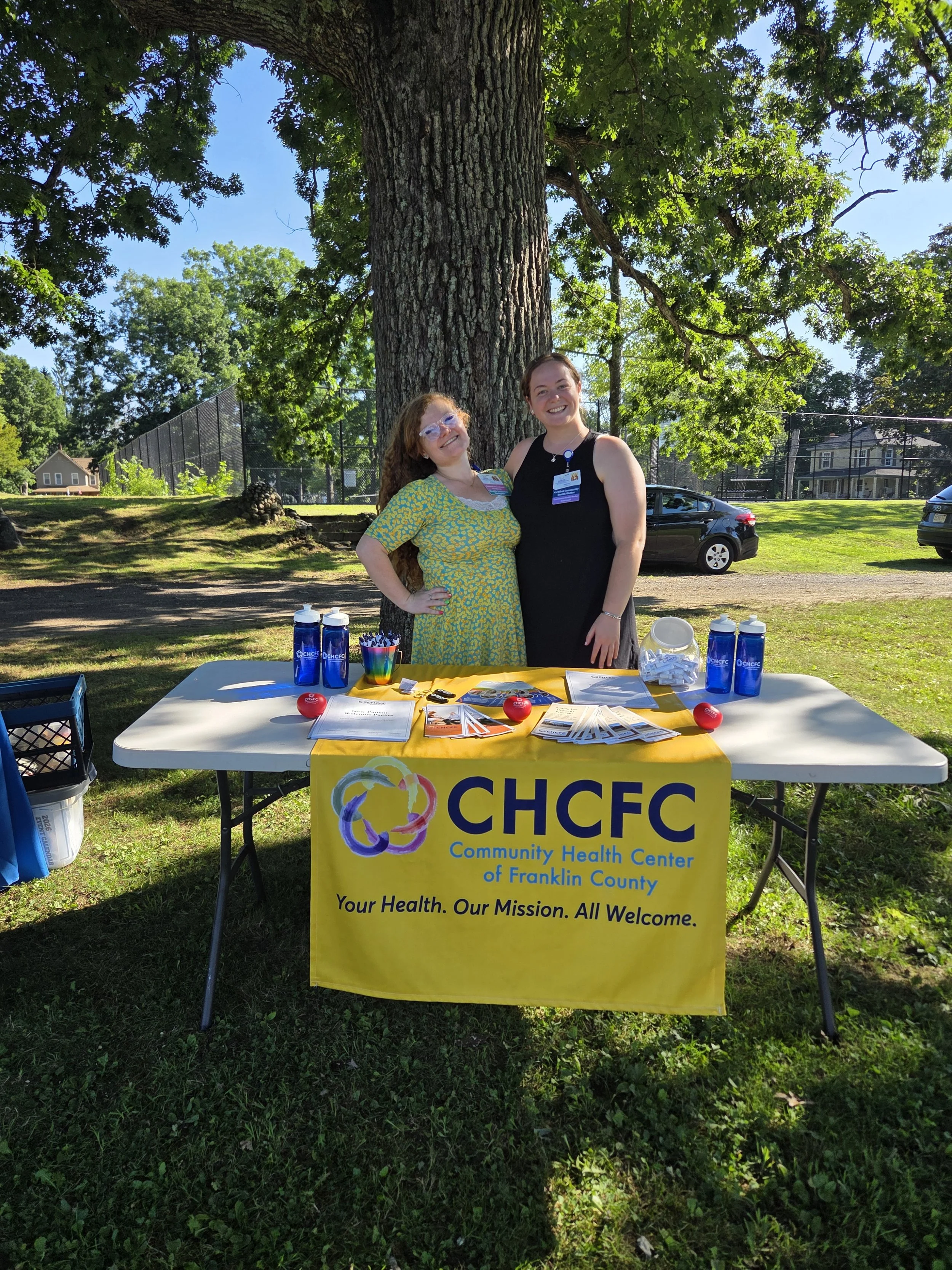 Another photo of two of our team members tabling outside.