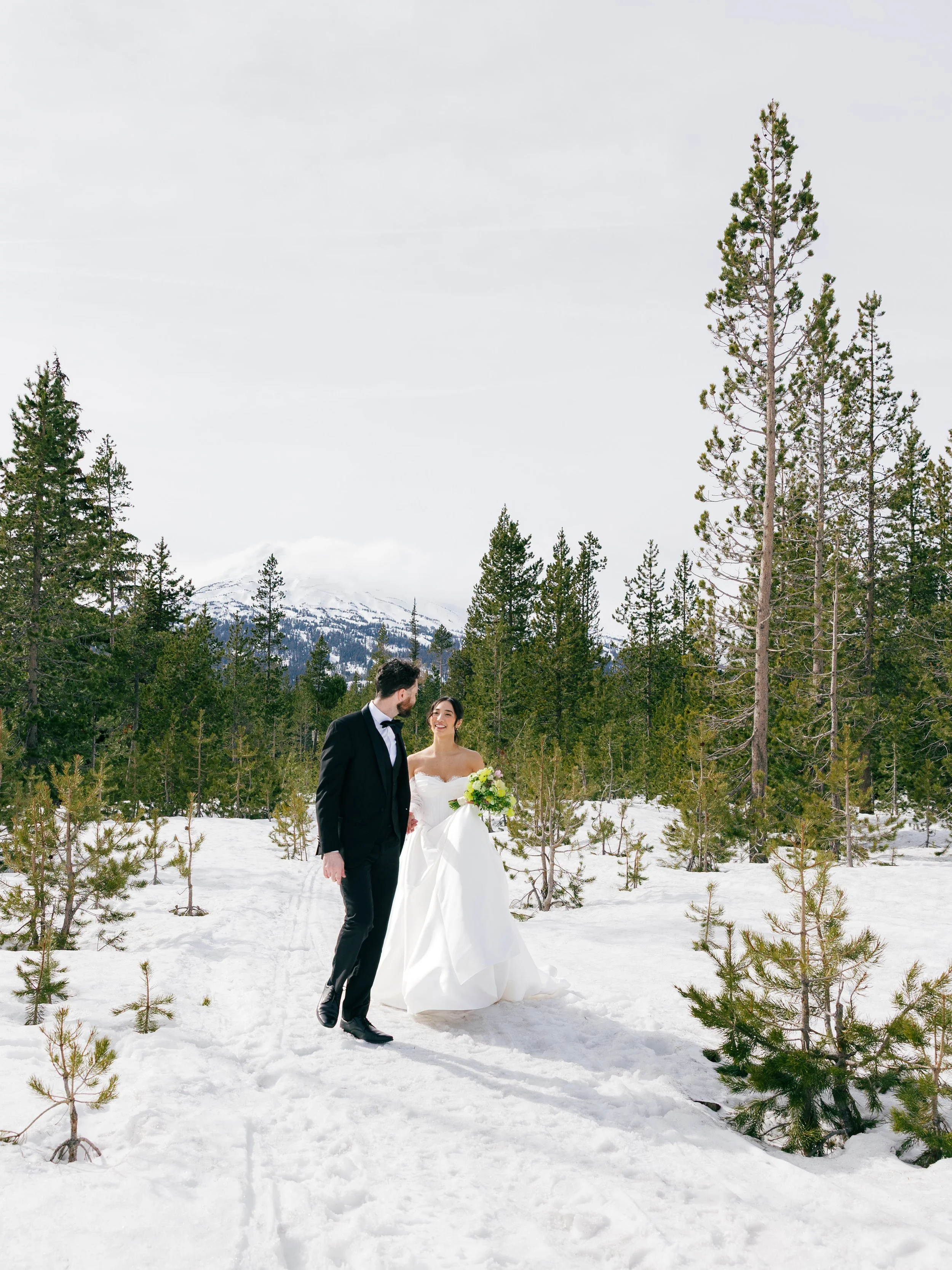 bride-and-groom-walking-in-snow-covered-woods.jpg