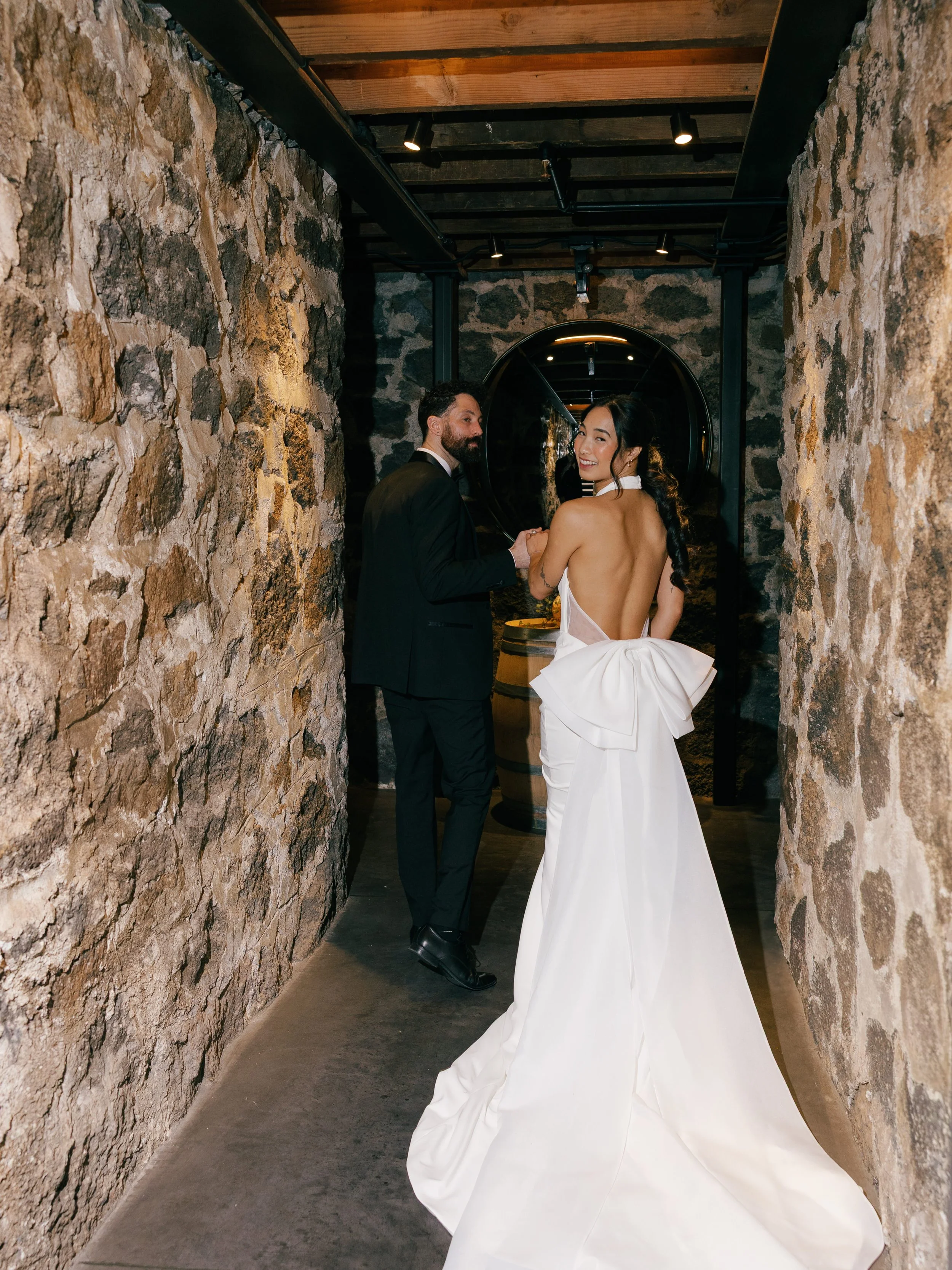 bride-and-groom-walking-through-stone-hallway.jpg