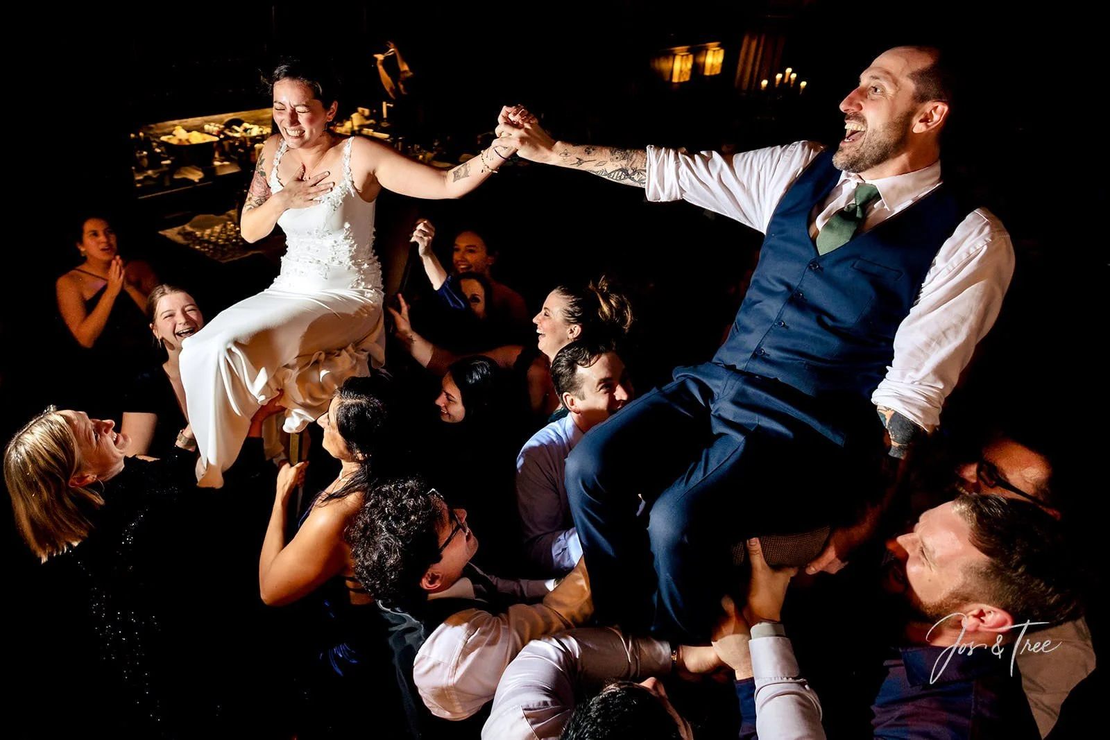 bride-and-groom-held-in-air-on-chairs.jpg