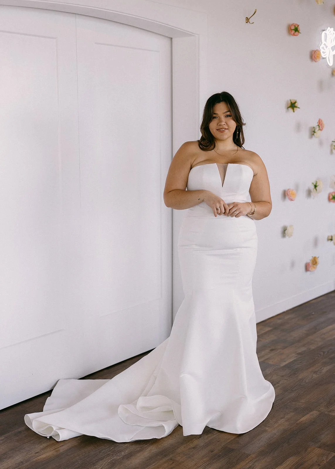 plus size bride wearing fitted satin dress with notch plunge neckline