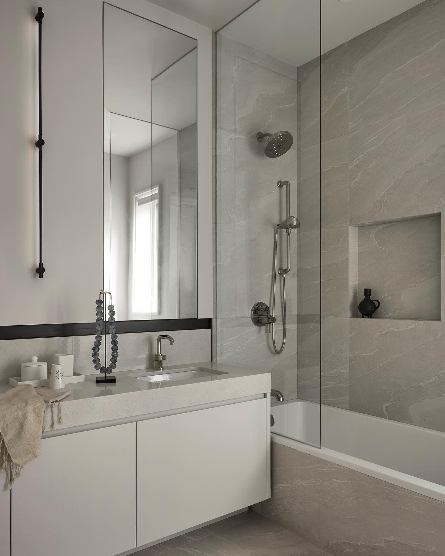 Minimal, spacious and light - a bathroom for our clients&rsquo; young daughters to share. Porcelain tiles and a substantial Ceasarstone countertop keep maintenance to a minimum, while a monochromatic palette with defined lines will serve as a timeles