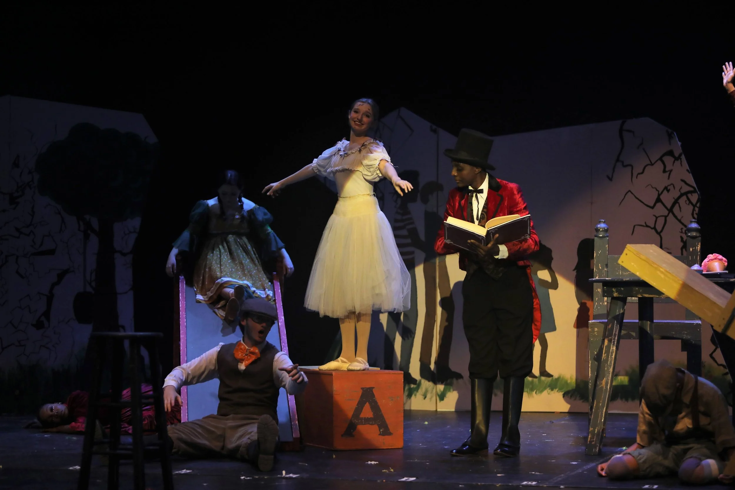 Men’s red 1900s tailcoat complete with black pants, boot toppers, white under shirt, and a double-breasted vest