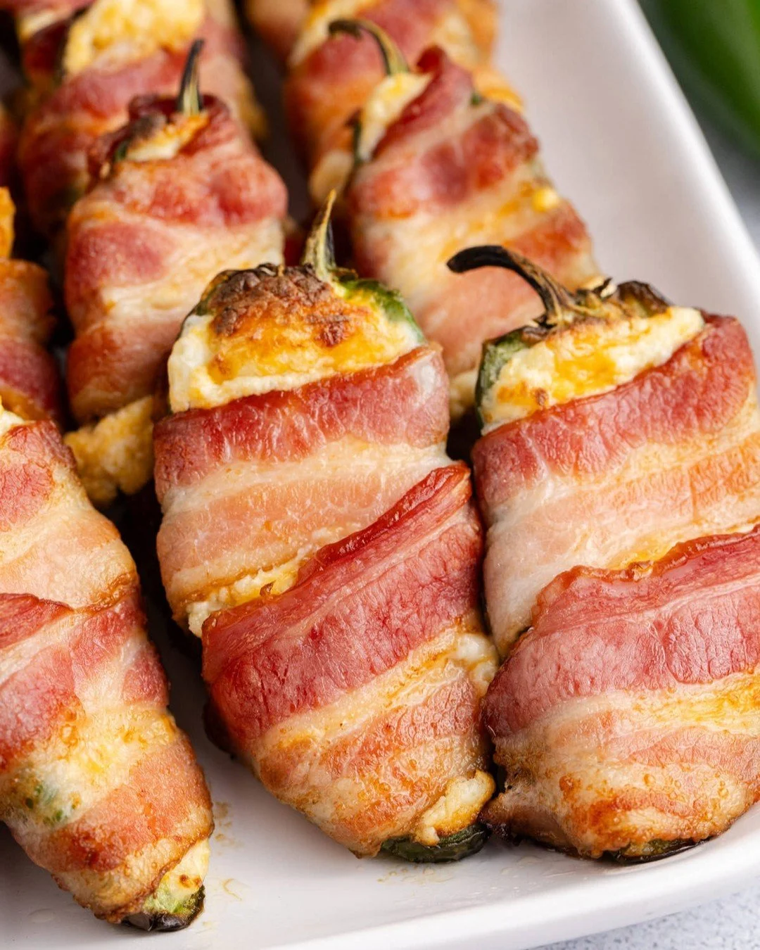 Crispy, cheesy, and just the right amount of heat &mdash; our air fryer Bacon-Wrapped Jalape&ntilde;o Poppers are the ultimate game day appetizer. Perfect for tailgates or casual get-togethers, these poppers come together quickly and disappear even f