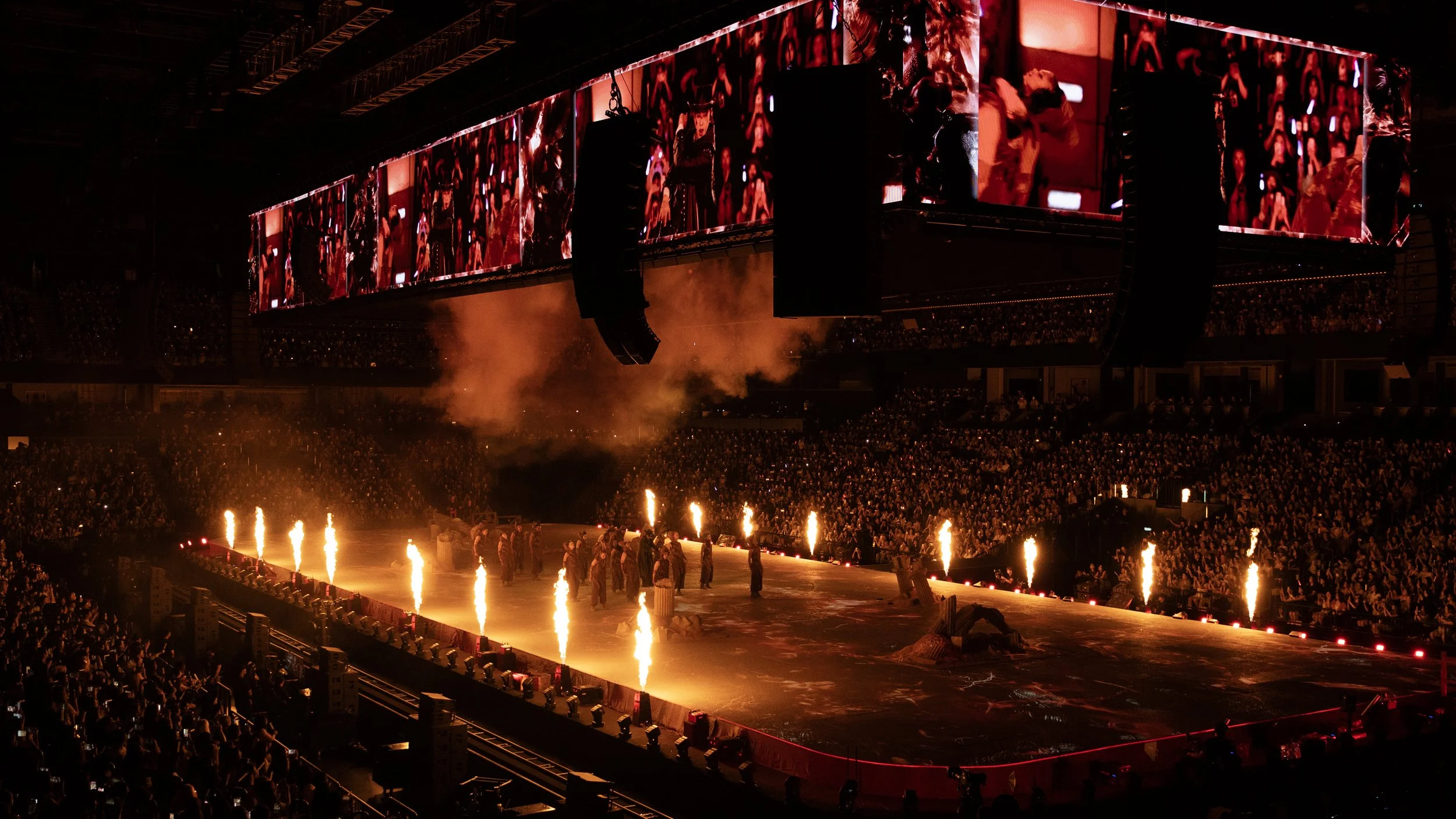 Wide arena view of KUN 蔡徐坤 DEADMAN with immersive floor landscape, fire effects and audience, set design by Ruby Law