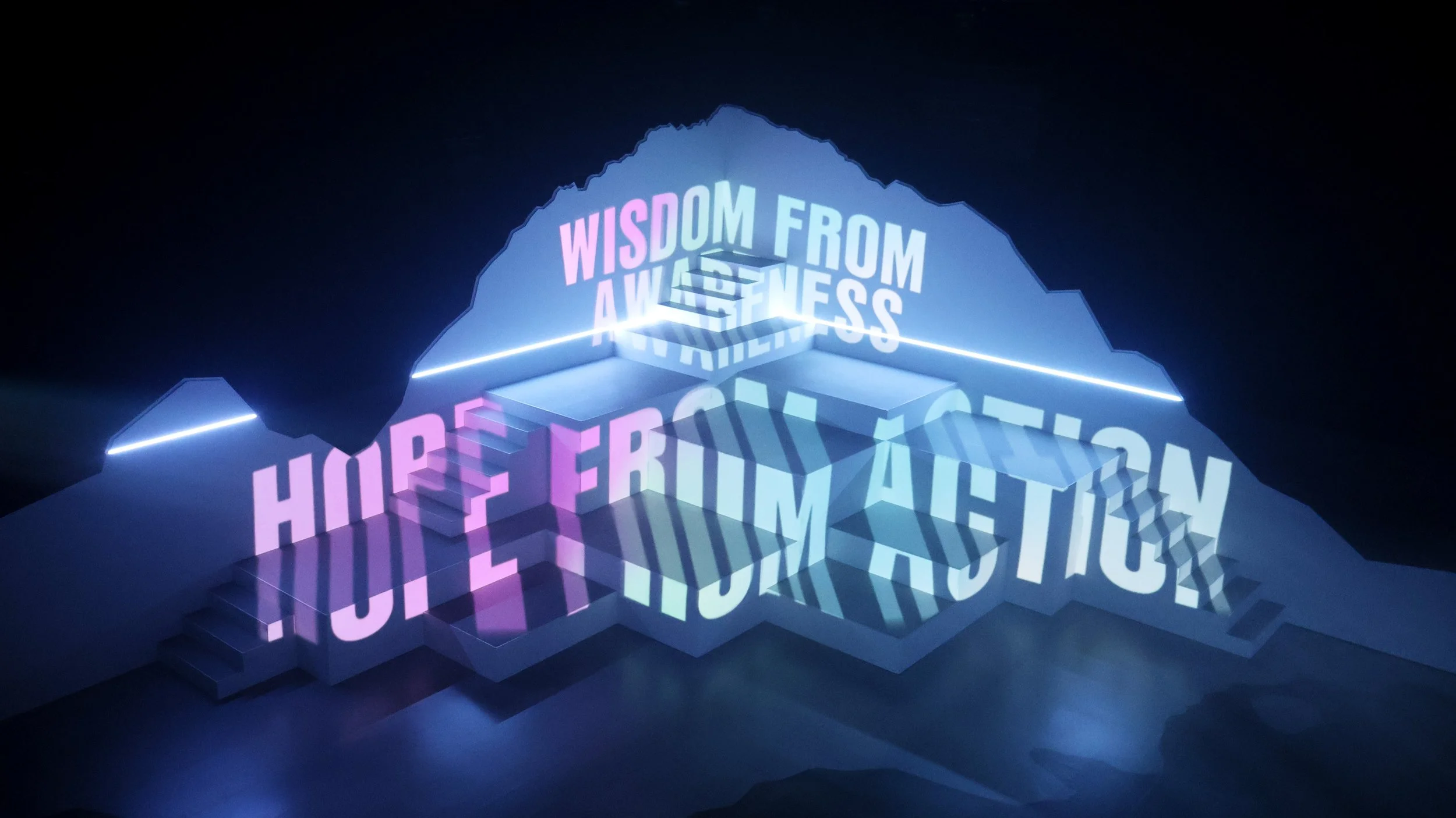 Typography projection across geometric mountain set reading Hope from Action, immersive design by Ruby Law RULA London