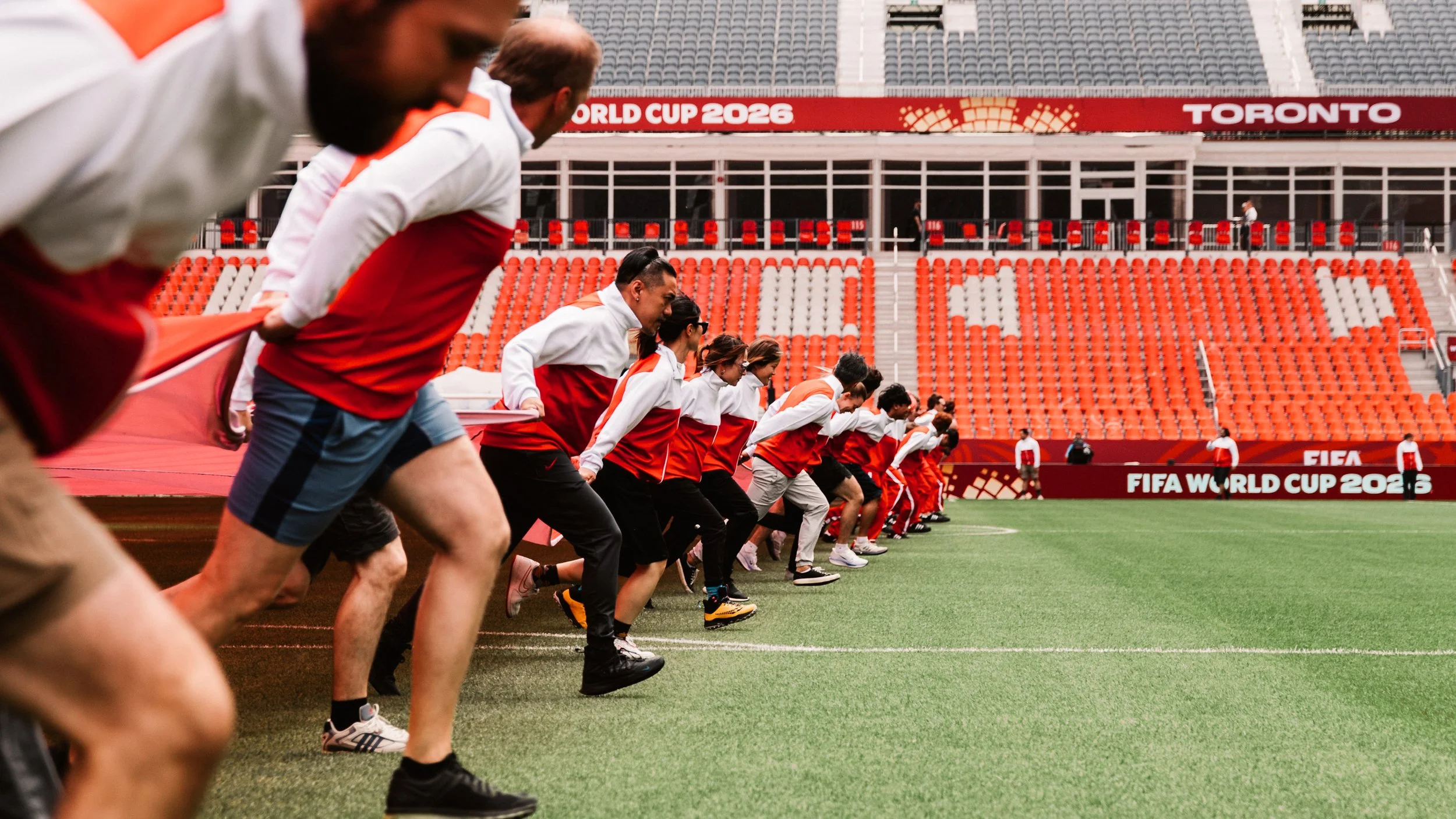 Behind the scenes as performers prepare the giant maple leaf field cloth for the FIFA World Cup 2026 Toronto Opening Ceremony.