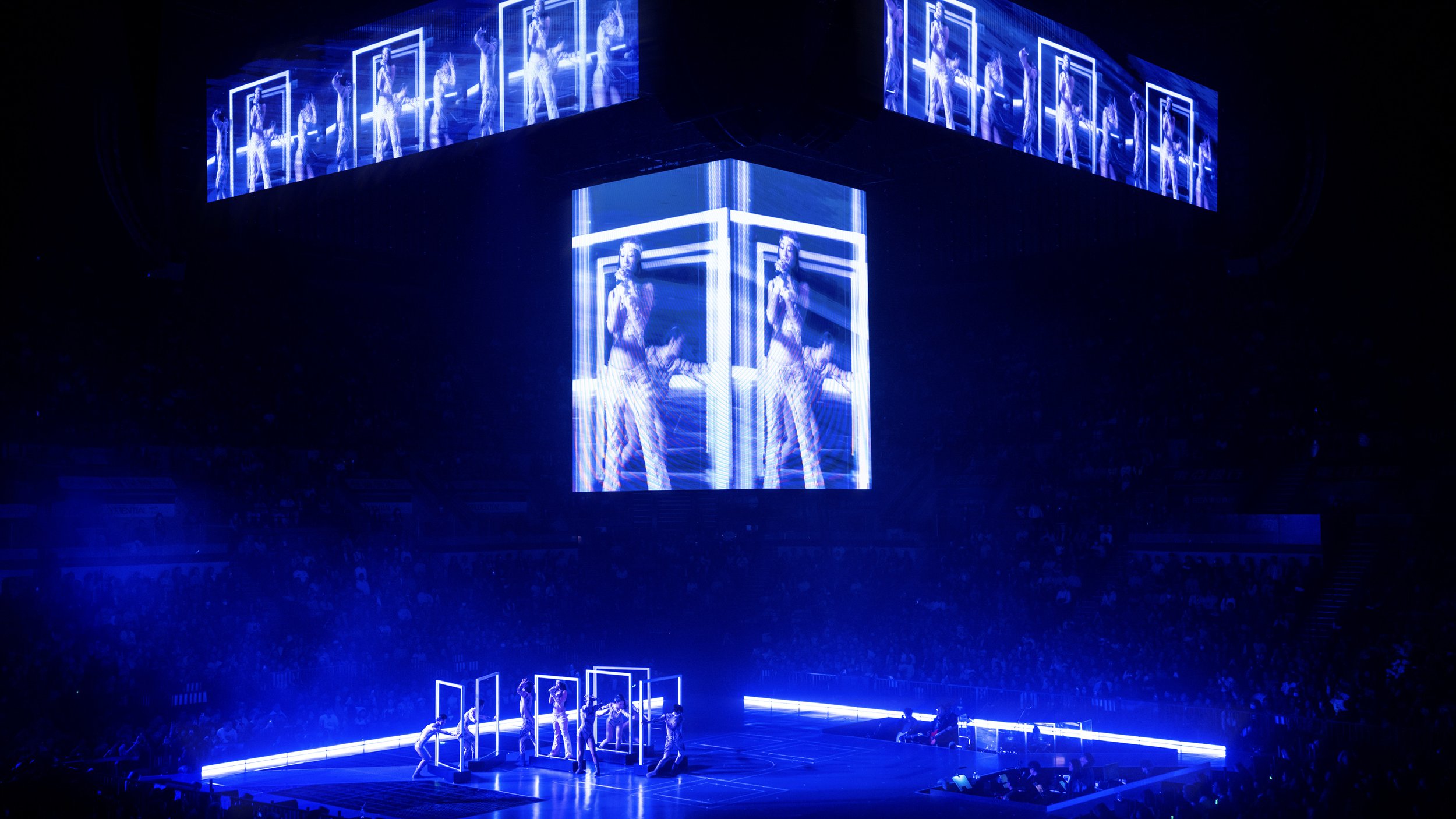 Jace Chan framed by illuminated cube structures symbolising transformation in Jace World, pop music set design by London set designer Ruby Law.