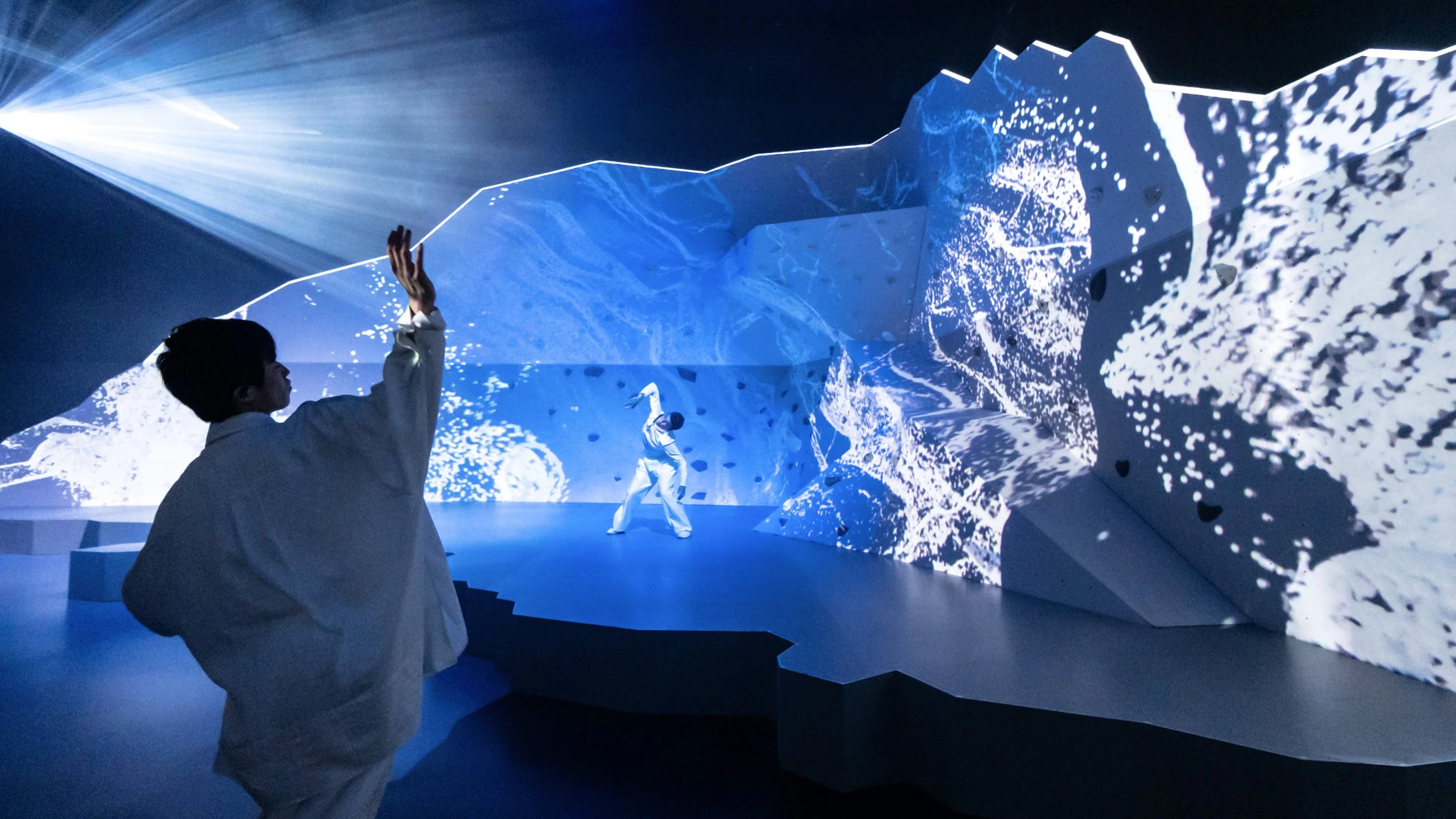 Projection-mapped mountain set with dancer, immersive scenic design by Ruby Law RULA London set designer