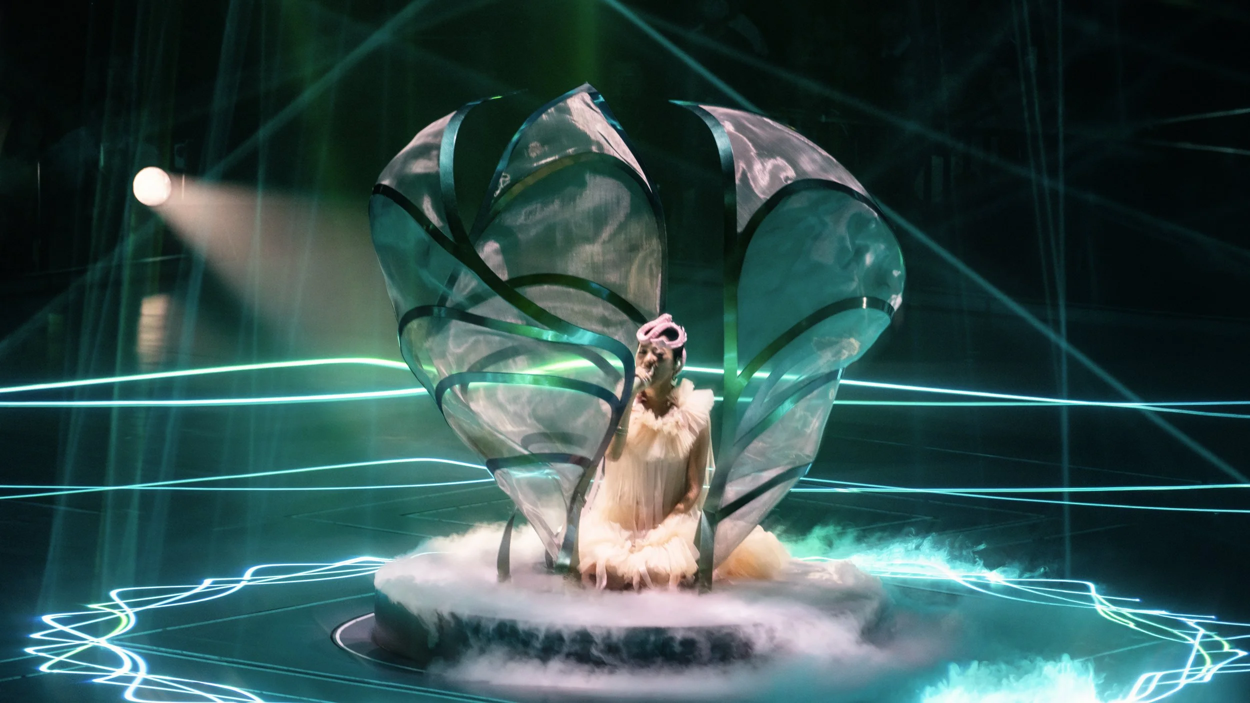 A cocoon props with Jace Chan performing inside, pop concert stage design by London set designer Ruby Law.