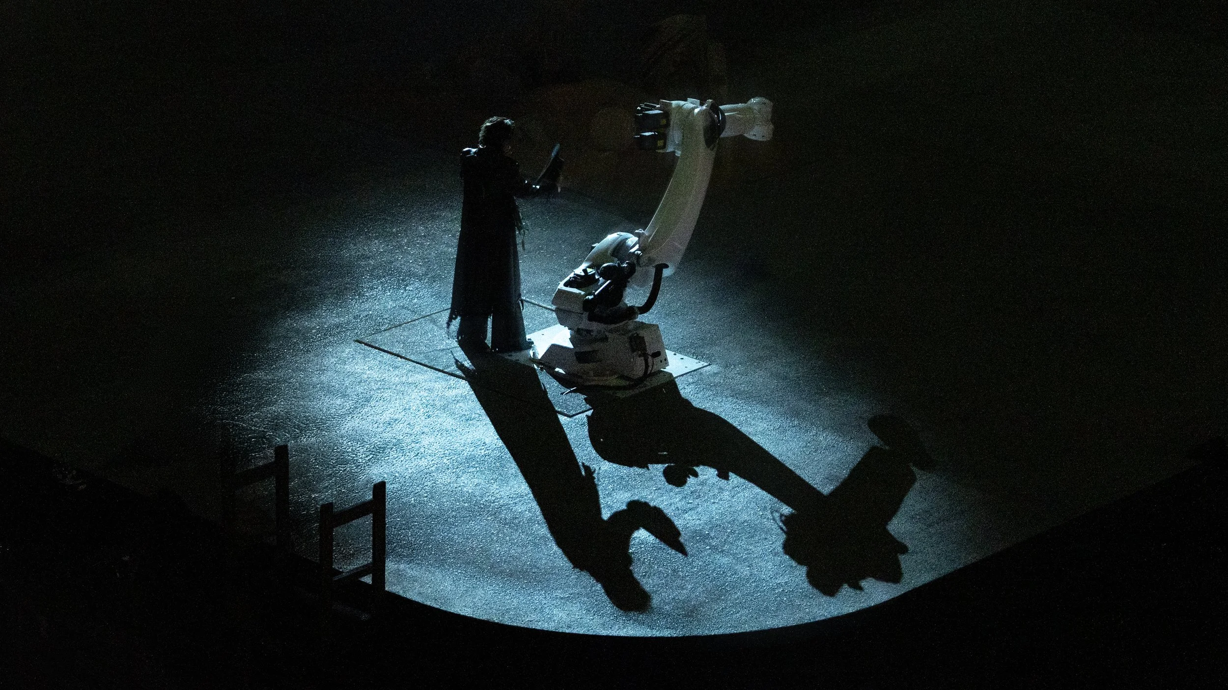 KUN 蔡徐坤 encounters an industrial robotic arm in the dystopian world of DEADMAN, stage design by Ruby Law