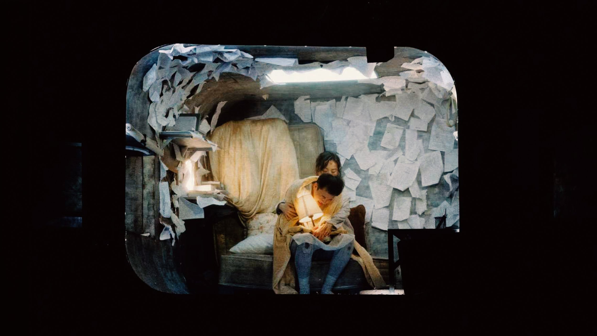 Perspective shot of the nest where the protagonist created in 'Metamorphosis'. Set design by Ruby Law (RULA), where the room is turned upside down, covered with paper and script.